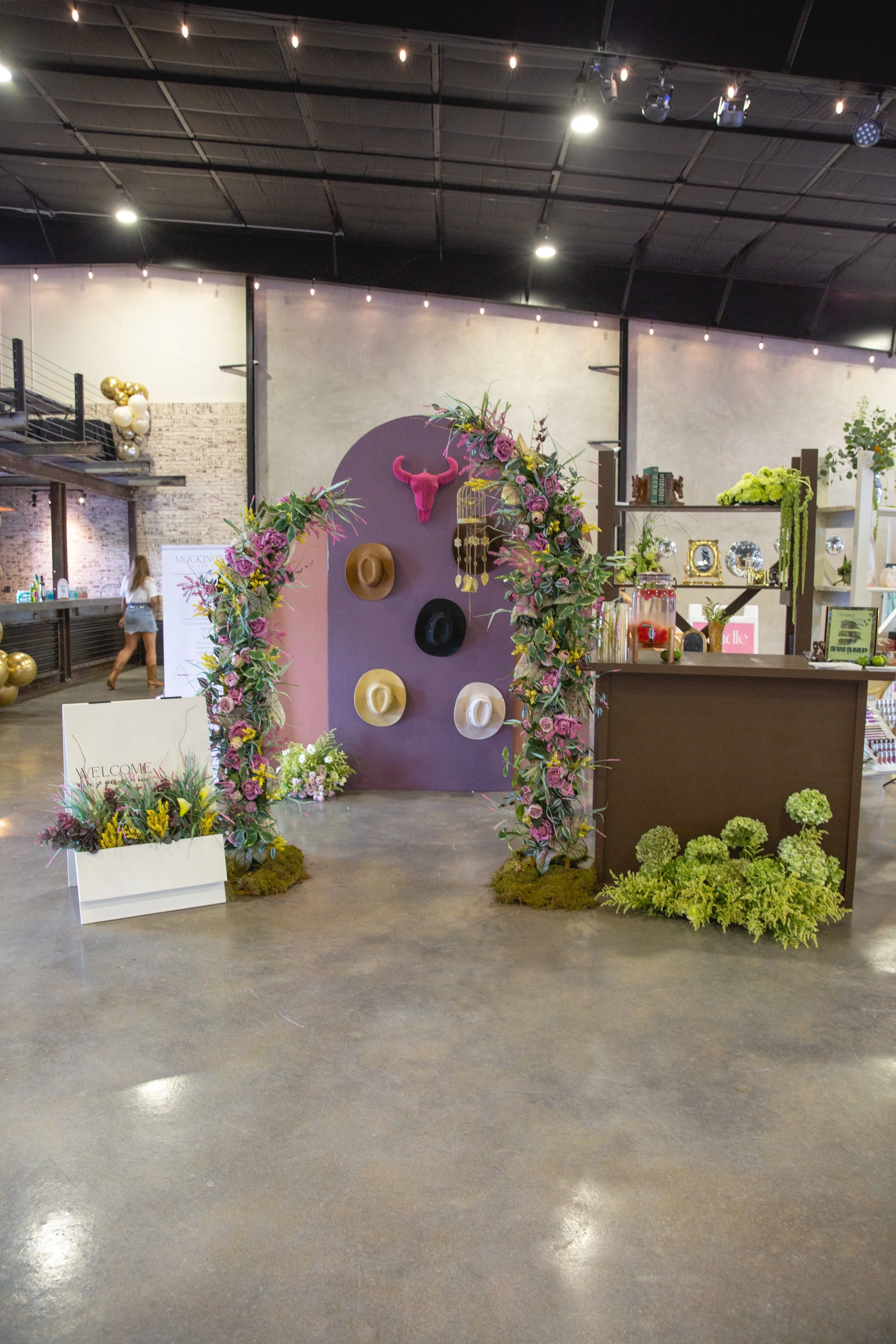 brown rentable event bar and floral arch