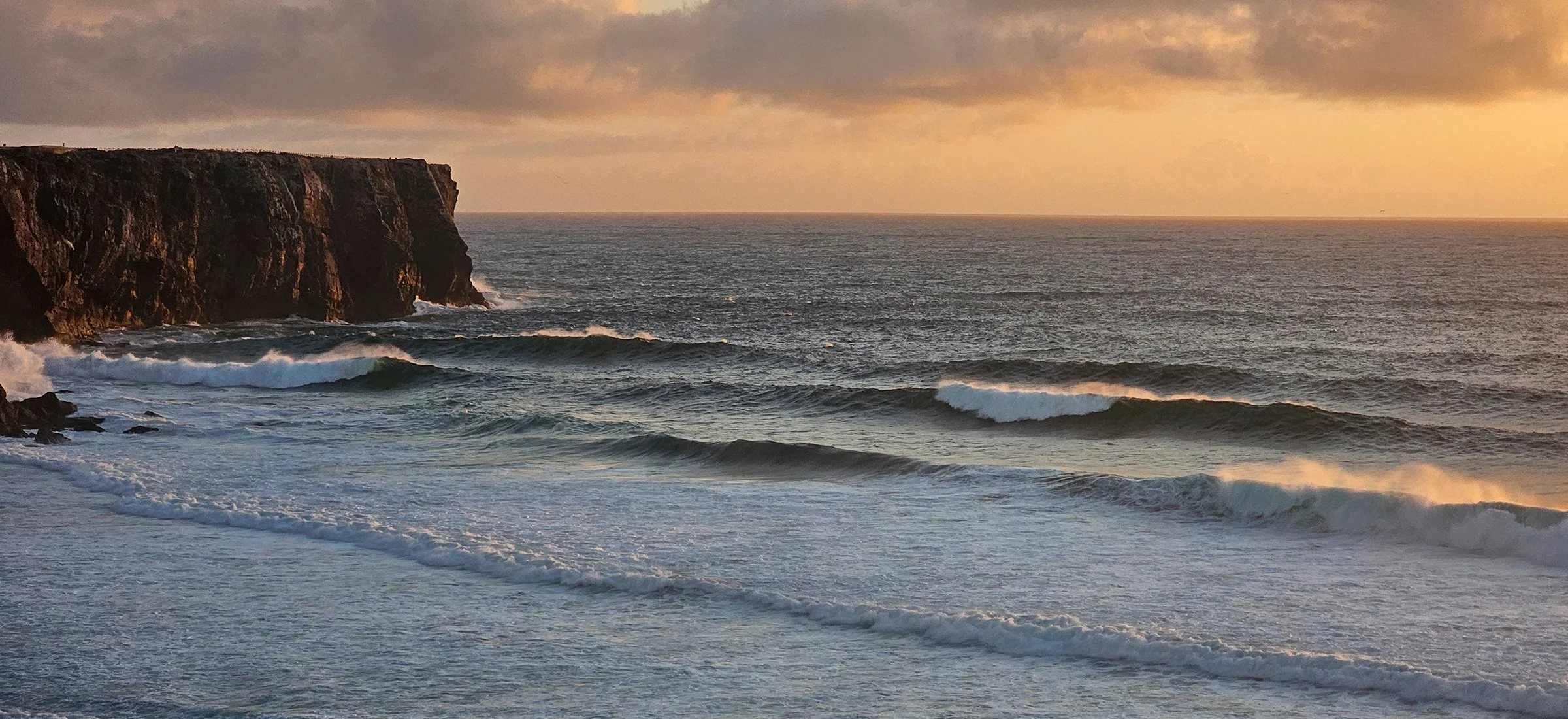sunset over stormy seas