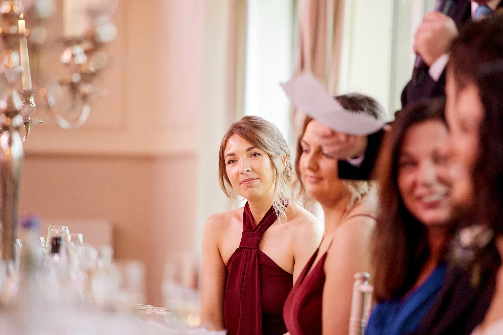 People sitting at a formal event, one person giving a speech.