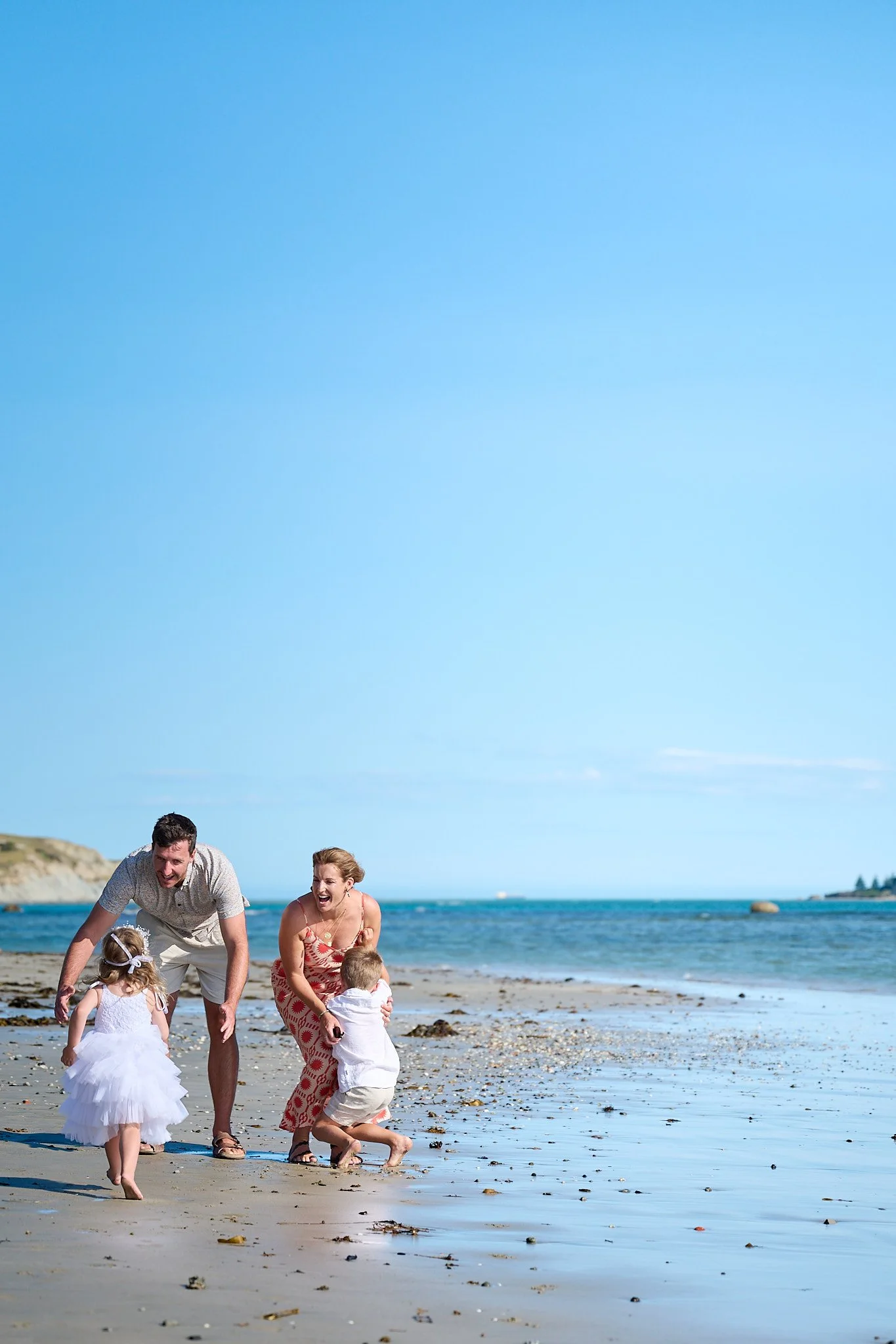 Family playing on the beach