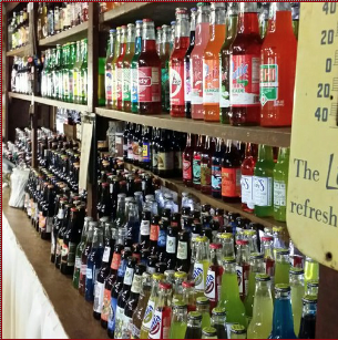 Shelf stocked with various bottled beverages in a store section.