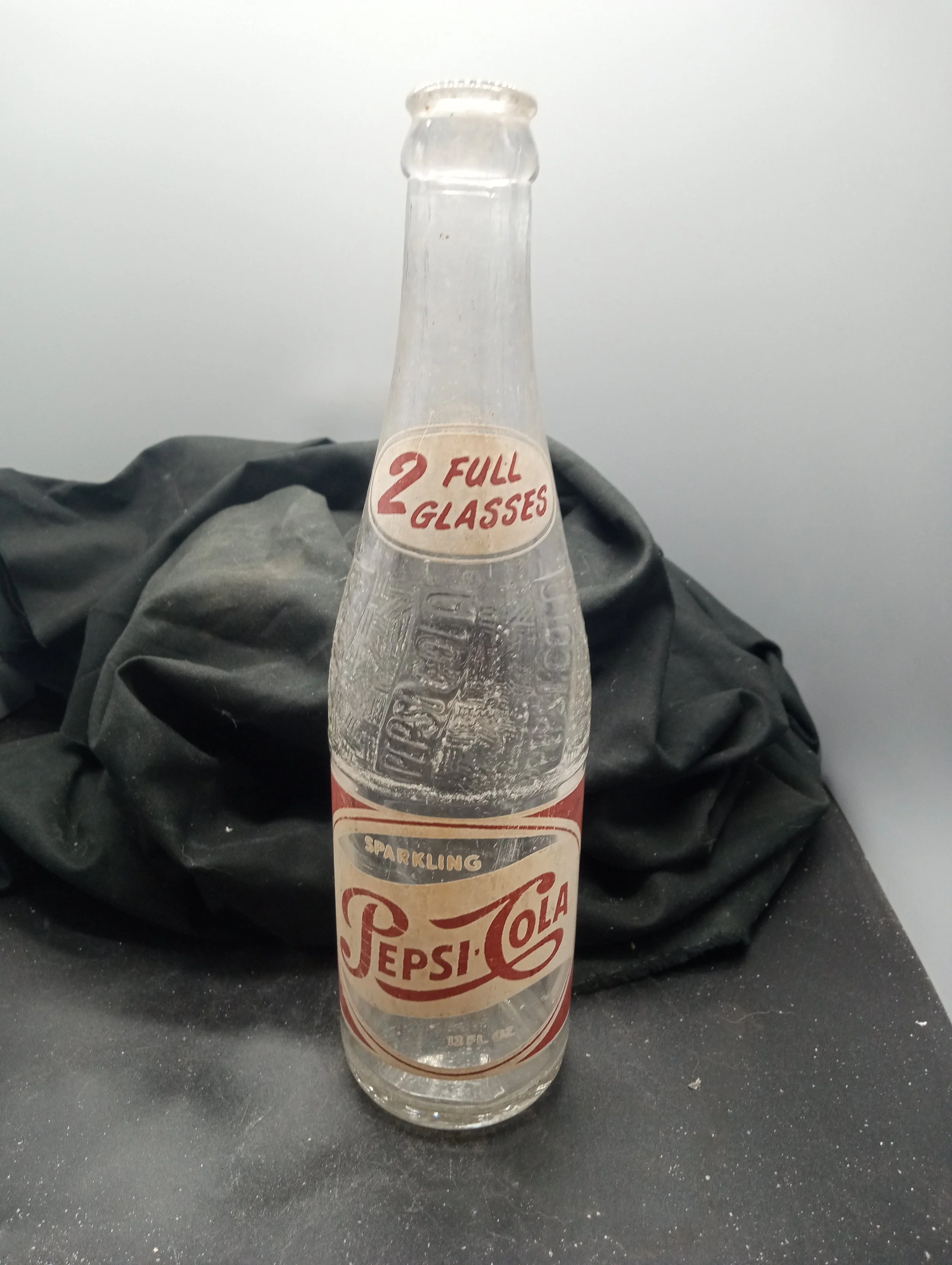 AGE - 1950 - TYPE - MACHINE - FRONT - (shoulder) 2 FULL / GLASSES (body) SPARKLING  / PEPSI-COLA / 12 FL. OZ. - BACK - FRANCHISED BOTTLER: / PEPSI-COLA BOTTLING CO. / GREENVILLE, S.C. - BOTTOM - DES. PAT. 120277 13  A 50  15 / L. G. W. - COLOR - CLEA