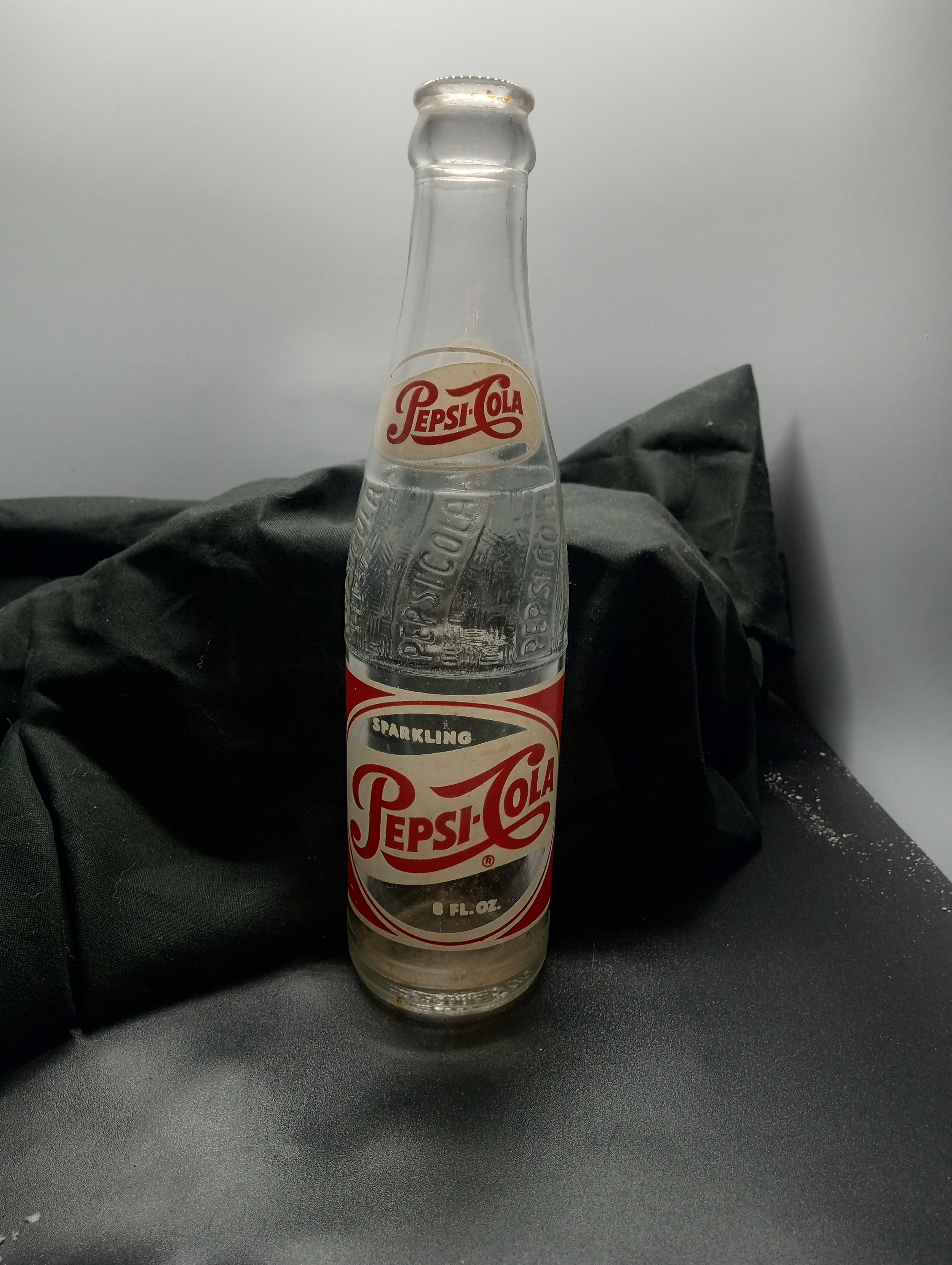 AGE - 1957 - TYPE MACHINE - FRONT - (neck) PEPSI.COLA (body) SPARKLING / PEPSI.COLA(R) / 8 FL. OZ. - BACK - (neck) PEPSI / 735 (body) FRANCHISED BOTTLERS / PEPSI-COLA BOTTLING CO. / COLUMBIA, S.C. - COLOR - CLEAR \ RARITY - SCARCE
