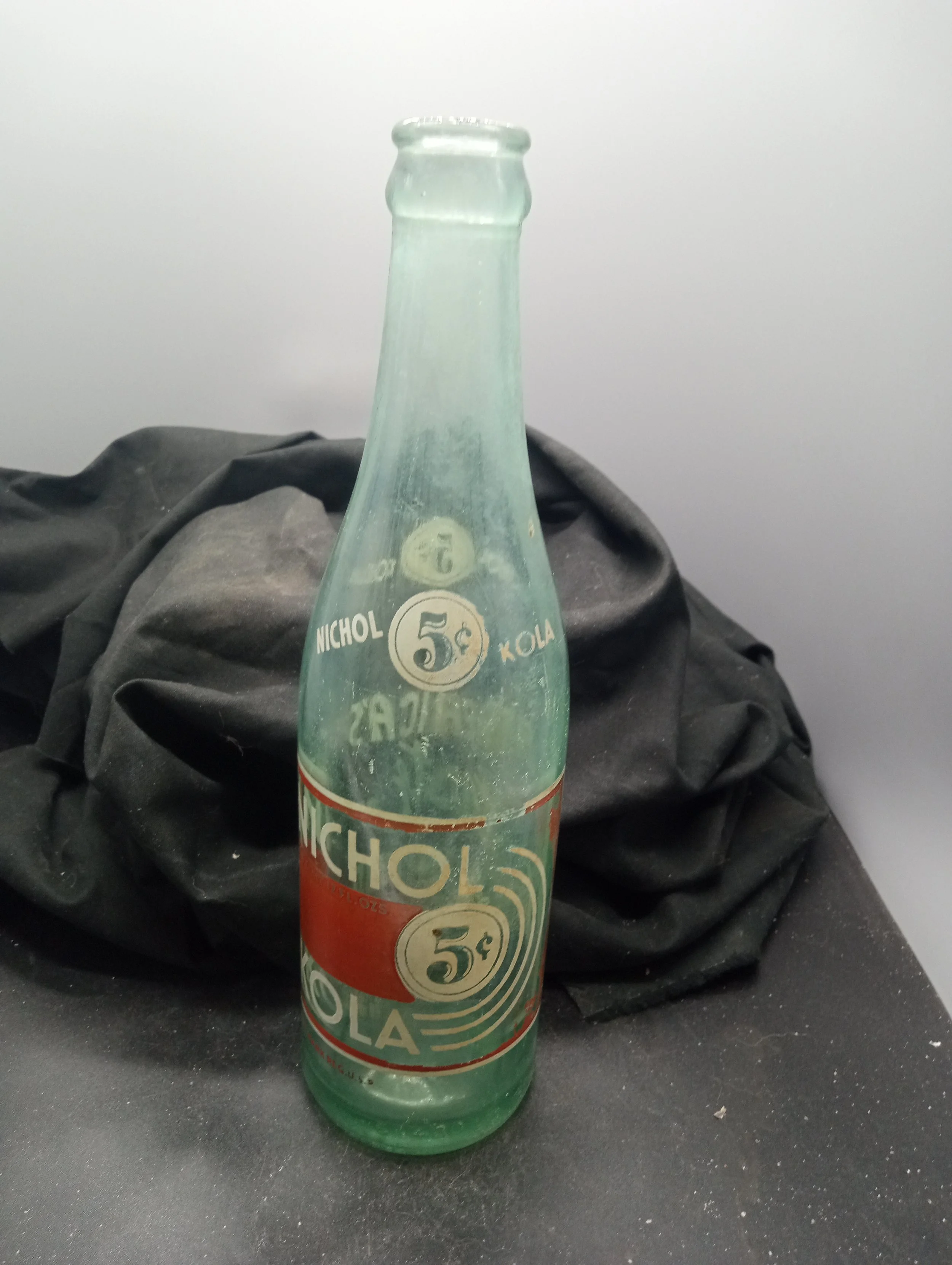 AGE - 1939 -  TYPE - MACHINE FRONT - (shoulder) NICHOL 5 KOLA (body) NICHOL / MIN. CONT. 12 FL. OZS. 5 / KOLA / TRADE MARK REG. U.S.A. (embossed at base) 6  430 - BACK - WOOD'S BEVERAGES / GAFFNEY, S.C. (embossed at base) 3 L G W 9  - COLOR AQUA \ RA