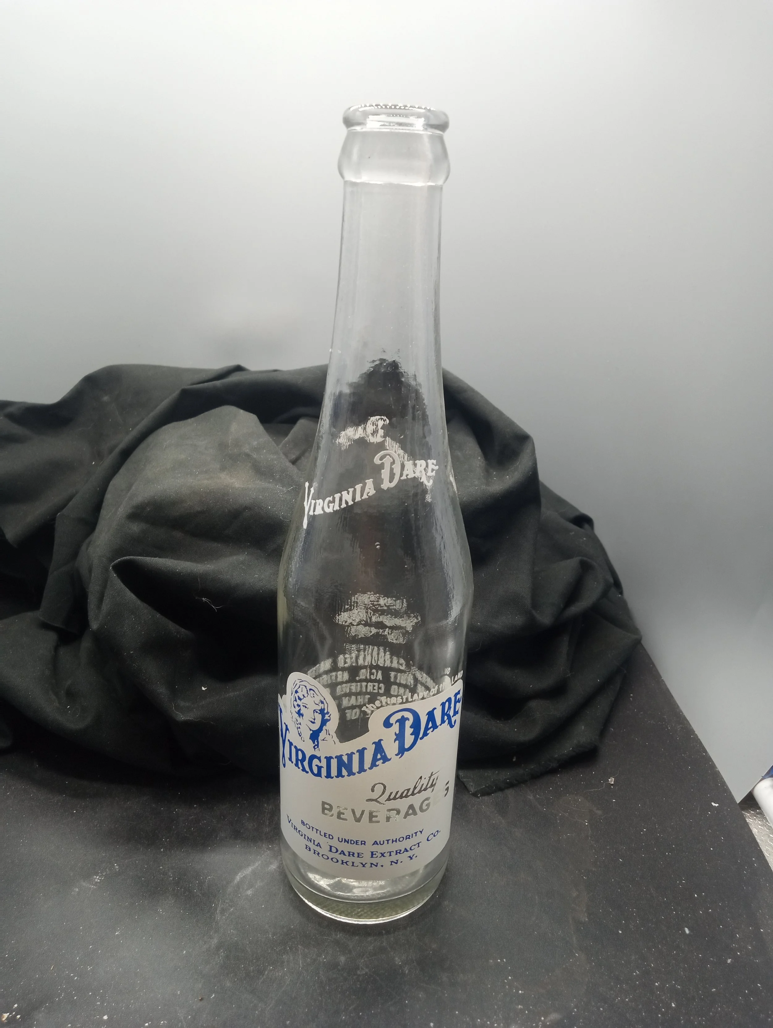 AGE - 1959 - TYPE - MACHINE - FRONT - (shoulder)  VIRGINIA DARE (body) THE FIRST LADY OF THE LAND / VIRGINIA DARE / QUALITY / BEVERAGES / BOTTLED UNDER AUTHORITY / VIRIGINIA DARE EXTRACT CO.  / BROOKLYN, N. Y.  - COLOR - CLEAR - RARITY - SCARCE - COM