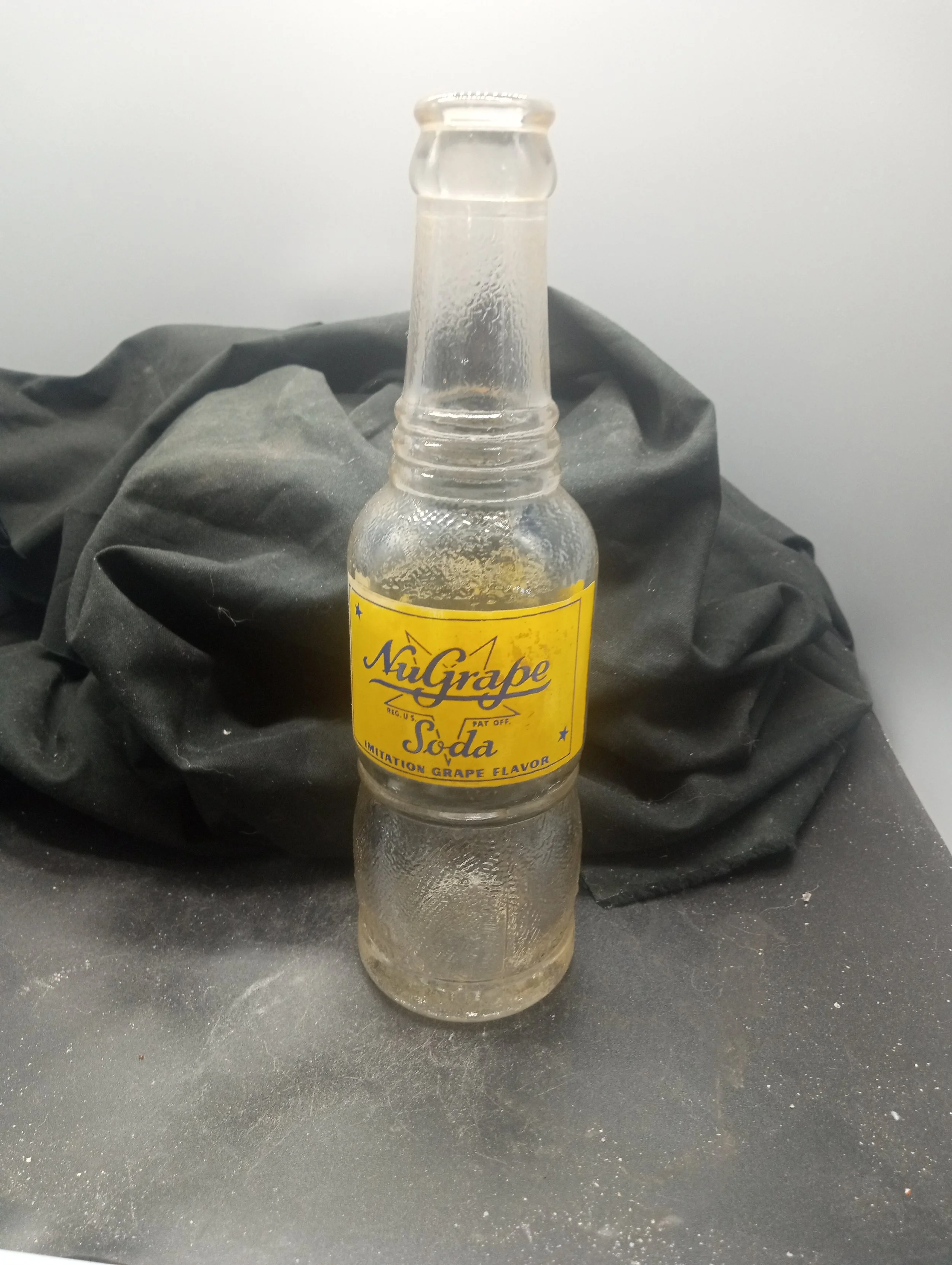 AGE - 1941 - TYPE - MACHINE - FRONT - NU GRAPE / REG. U.S.  PAT. OFF. / SODA / IMATION GRAPE FLAVOR - BACK - MIN. CONTENTS 6 FLU. OZS. / NU GRAPE SODA / IMATION GRAPE FLAVOR / SUN CREST BOTTLING CO. / CHARLOTTE, N.C. - FLORENCE, S.C. (embossed at bas