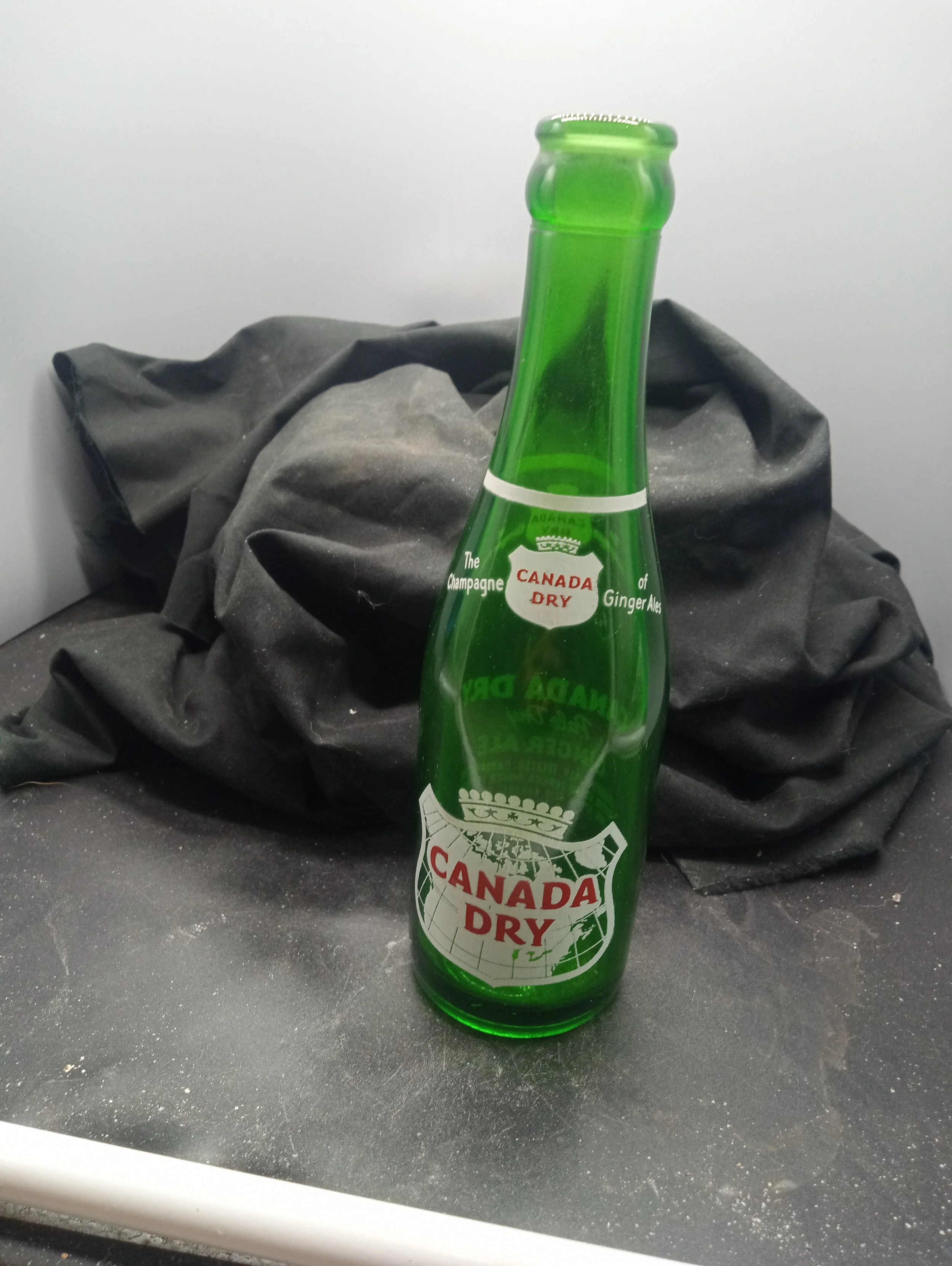 AGE - 1953 - TYPE - MACHINE - FRONT - (shoulder) THE CHAMPAGNE / CANADA DRY / OF GINGER ALES (body) CANADA / DRY - BACK - CONTENTS  7 FLUID OZS. / MANUFACTURED AND BOTTLED BY / CANADA DRY BOTTLING CO. / CLINTON, S.C. - G-94 / 3 (I) 53 / 9.  - COLOR -