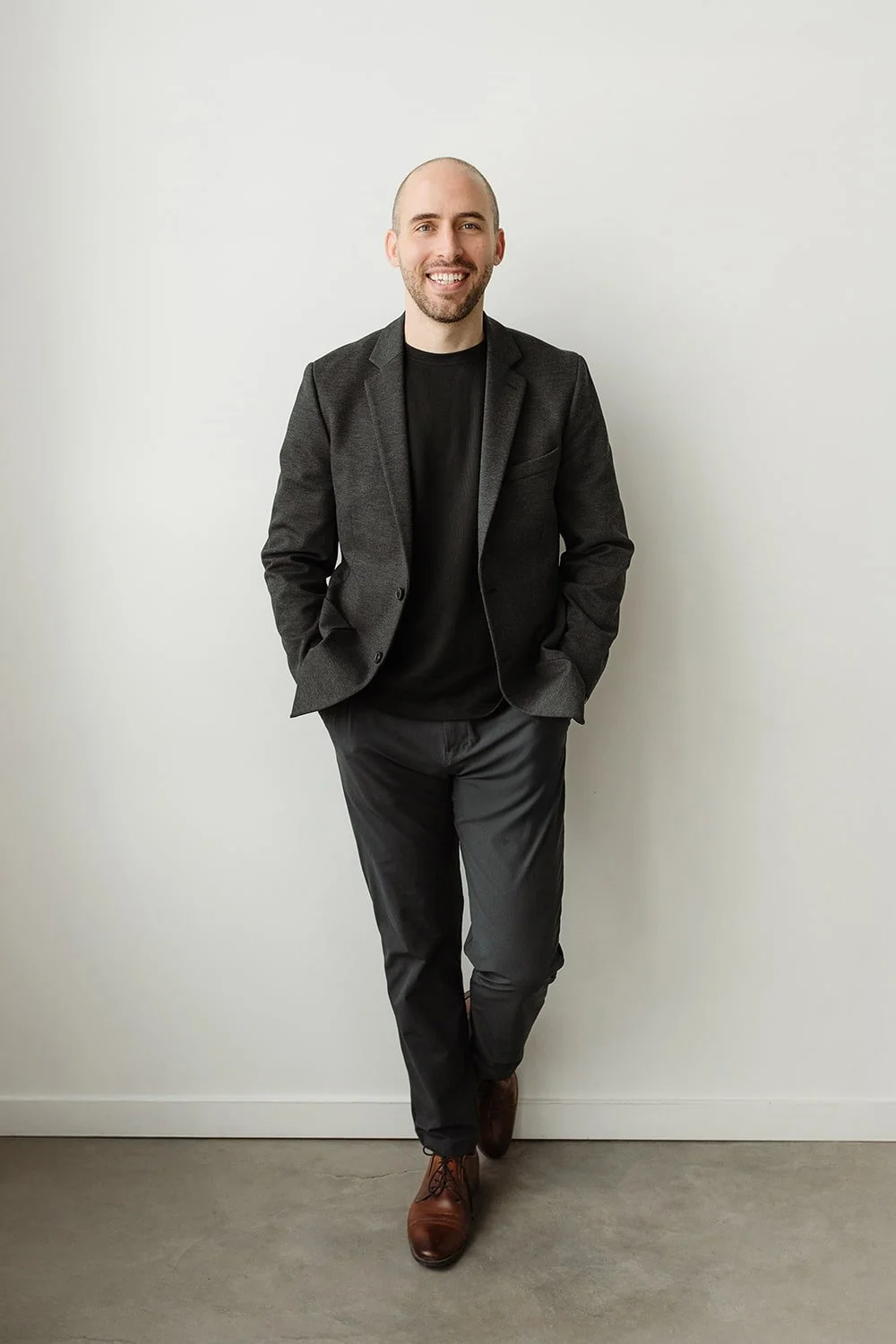 Calgary psychologist, Joel Mader sitting in a chair in his office.