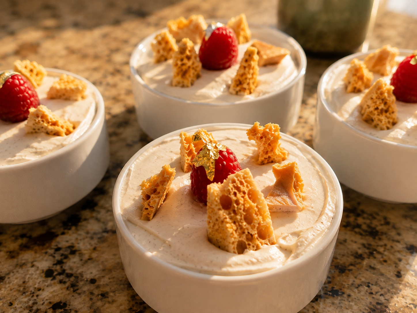 Individual chocolate mousse desserts topped with whipped cream and honeycomb candy