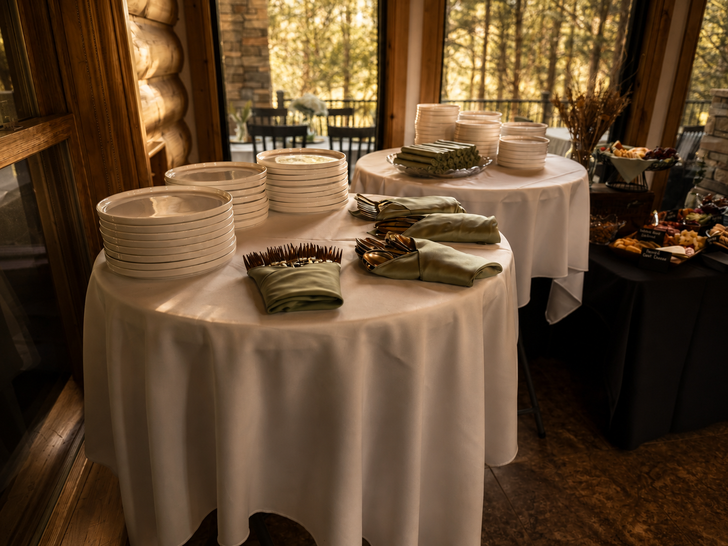 Plates, linens, and serving pieces arranged for a private event