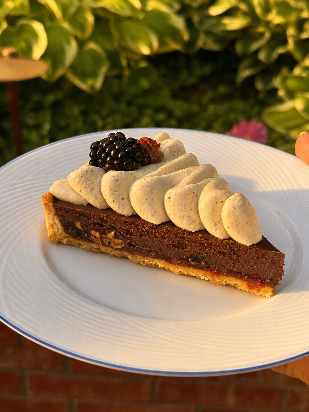 Chocolate tart with piped hazelnut whip and fresh blackberry