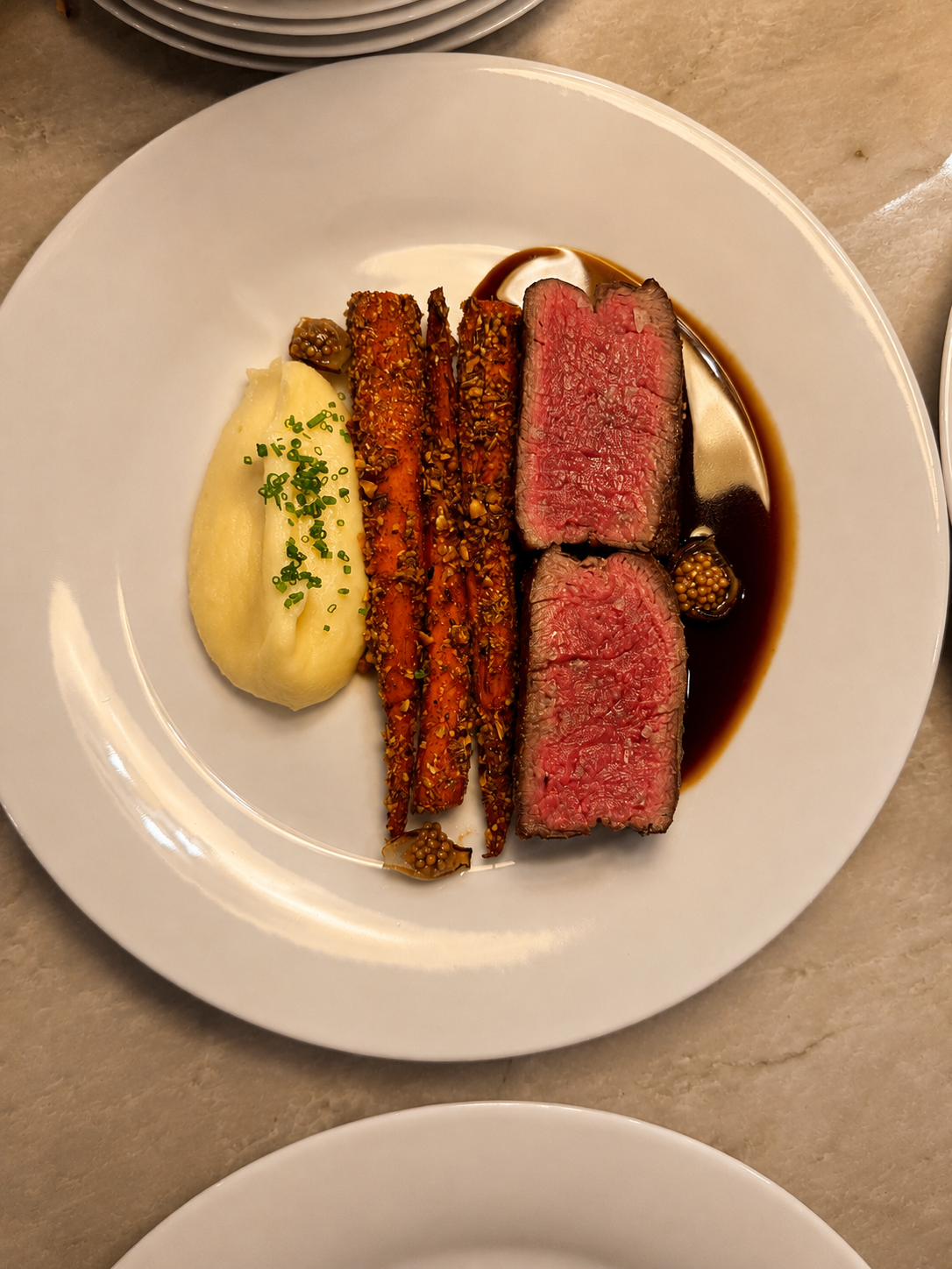 Sliced beef filet entree with roasted carrots and potato puree