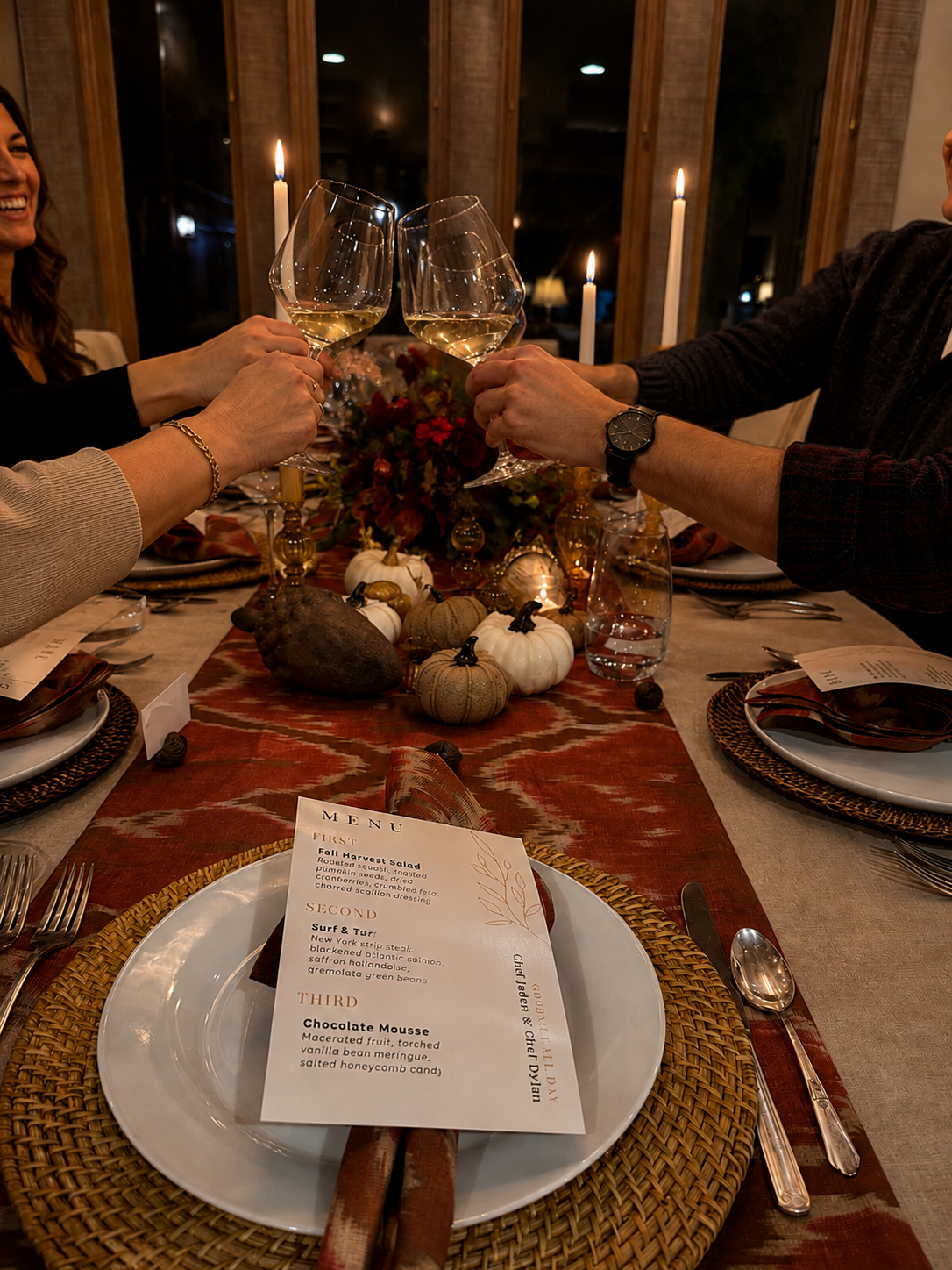 Guests raising wine glasses around a candlelit dinner table