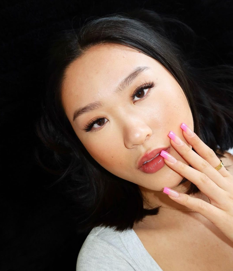 Close-up portrait of a young woman with black hair, wearing light makeup being a model for eyelash extensions. Nicole Rutherfurd the owner of LABB created this set of Mega Wispy Eyelashes