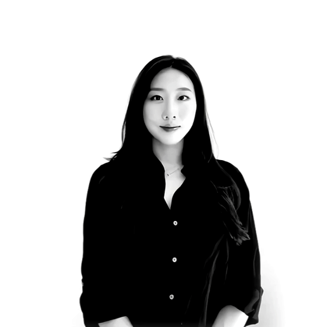 Black and white photo of a woman with long dark hair wearing a black button-up shirt against a plain white background.