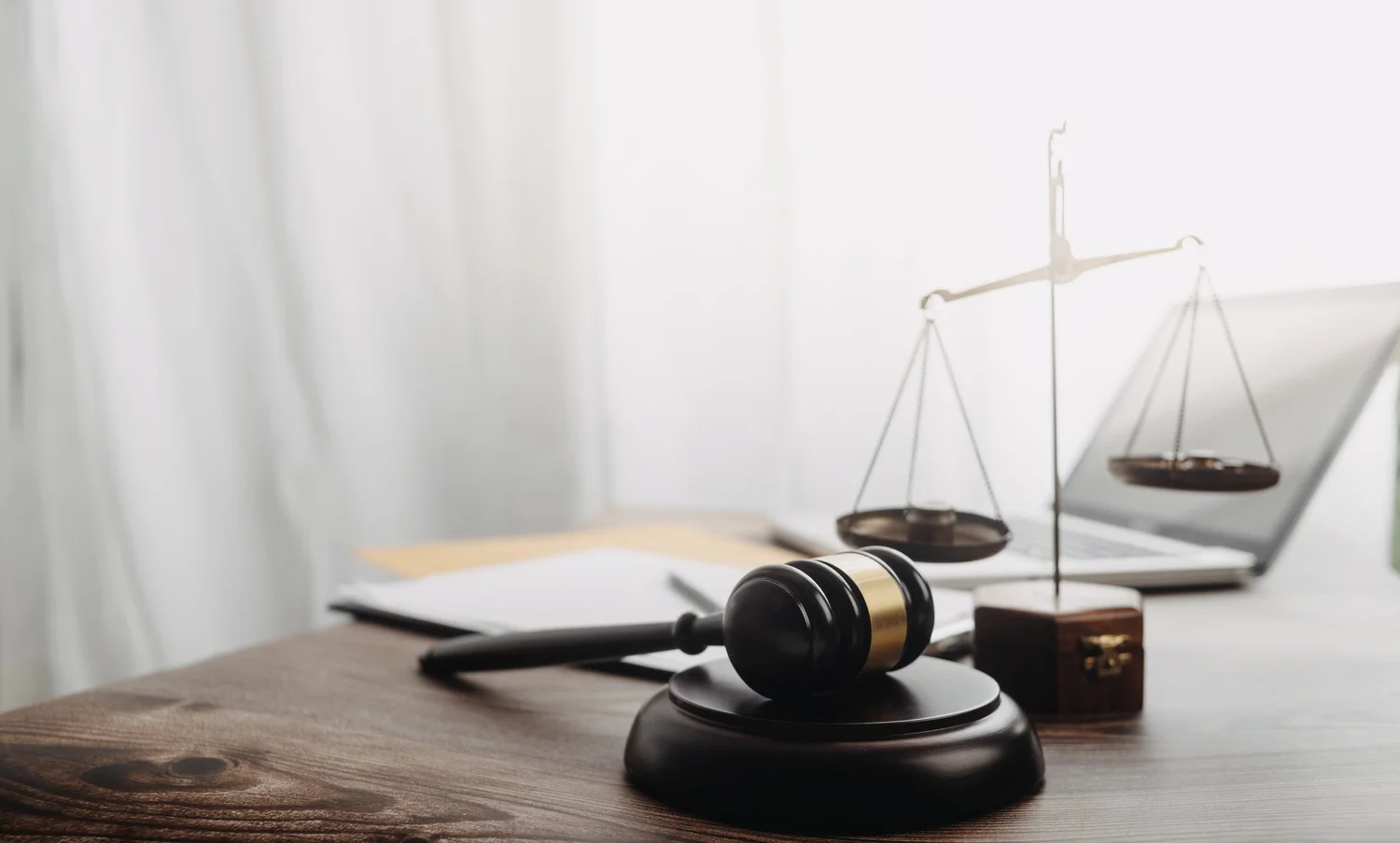 Scales of justice and a gavel on a desk