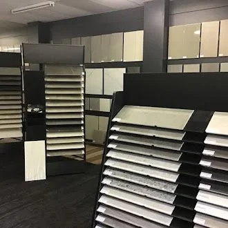 Display of various tile or countertop samples in a showroom.