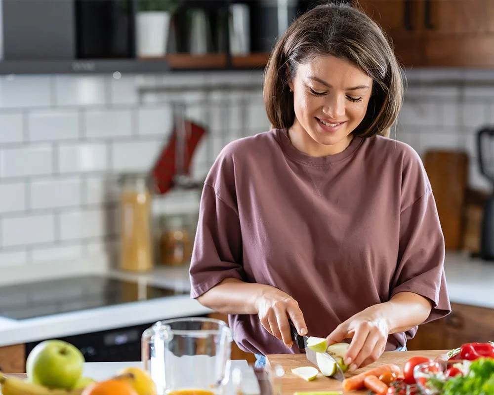 woman slicing fruits and vegetables