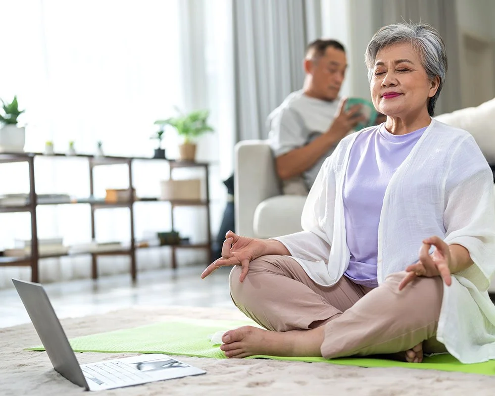 older woman performing meditation exercises