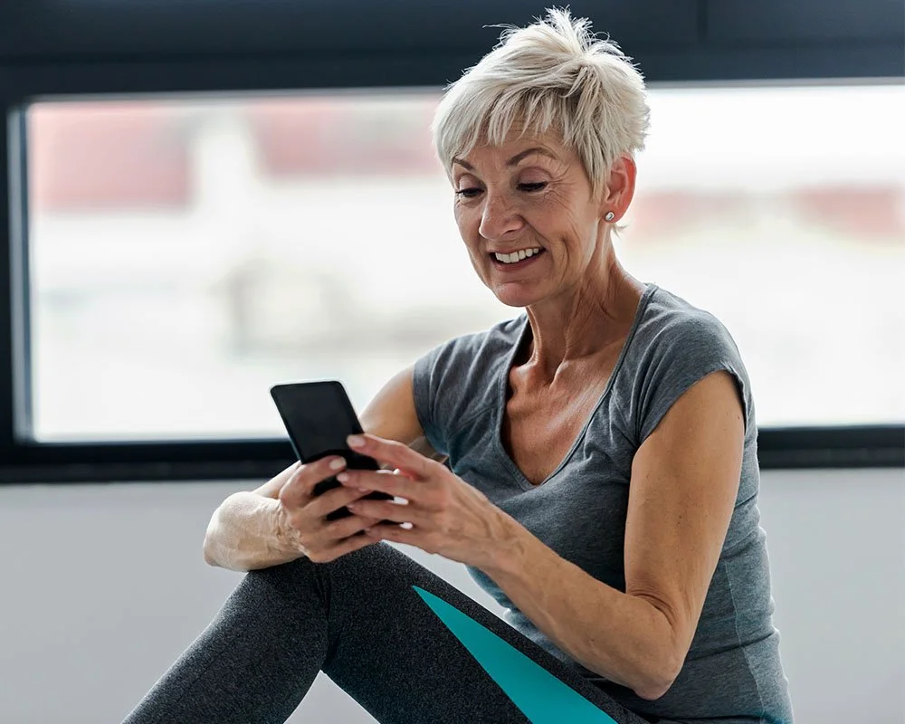 woman smiling looking at phone