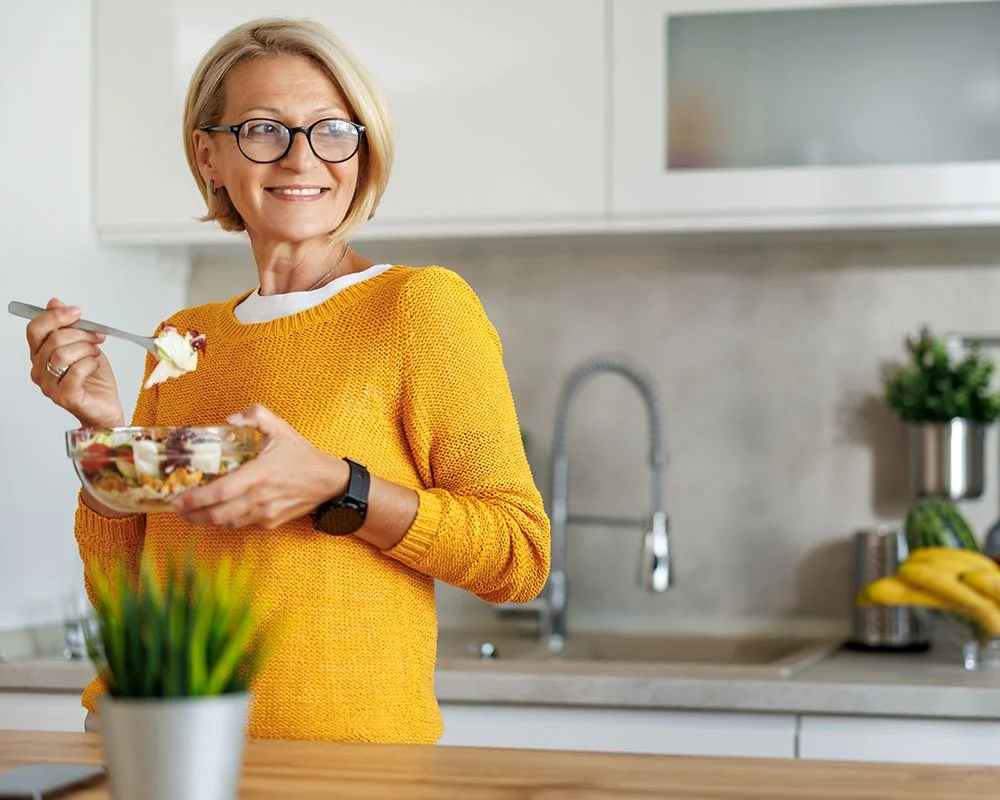 older woman eating a salad