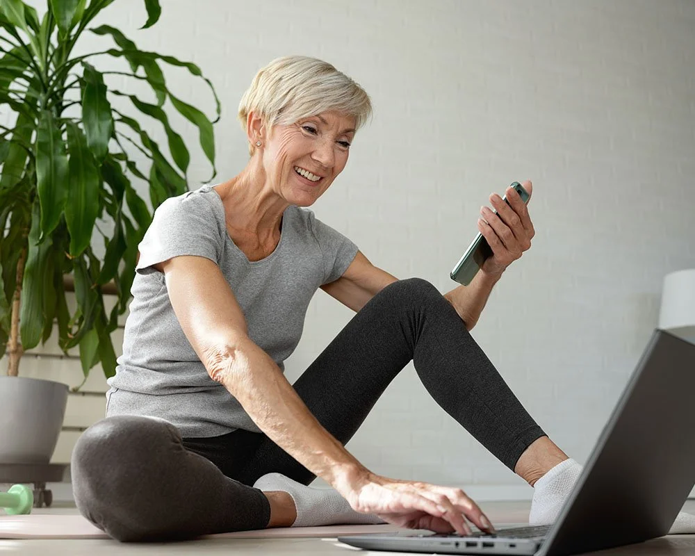 Older woman typing on laptop