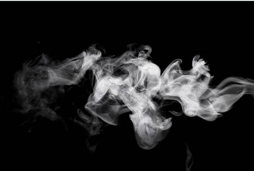 White smoke wisps against a black background.