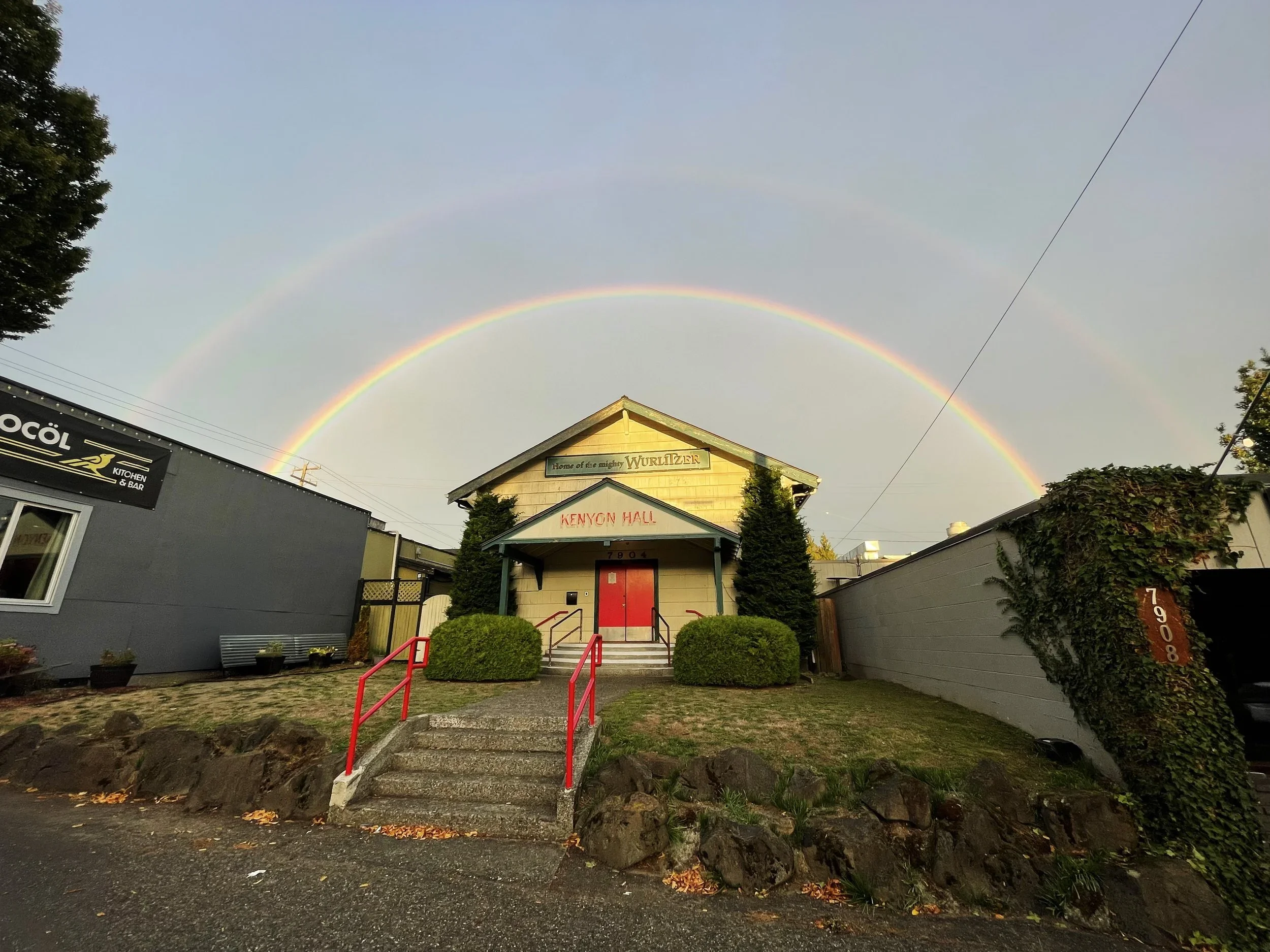 Kenyon Hall exterior under a double rainbow in 2023