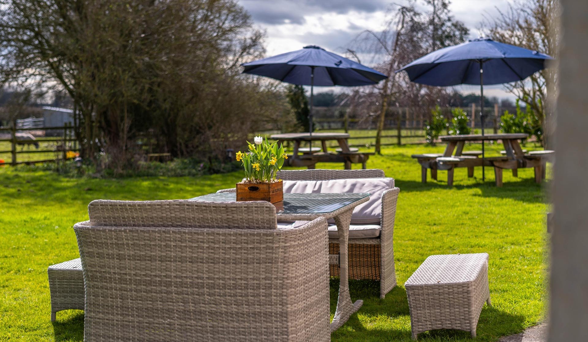 Clayfield Farmhouse garden with outdoor furniture on the grass