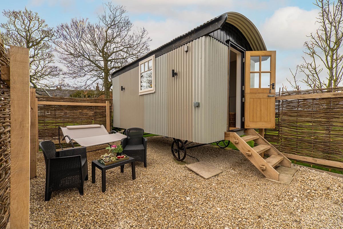 Clayfield Farm shepherd's hut private patio with outdoor furniture