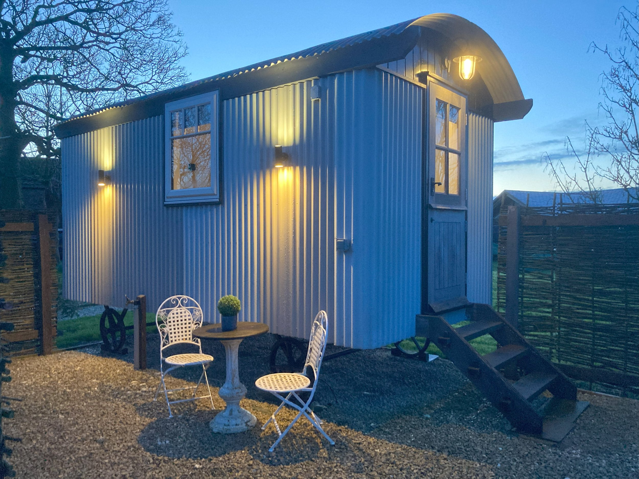 Clayfield Farm shepherd's hut outside at dusk
