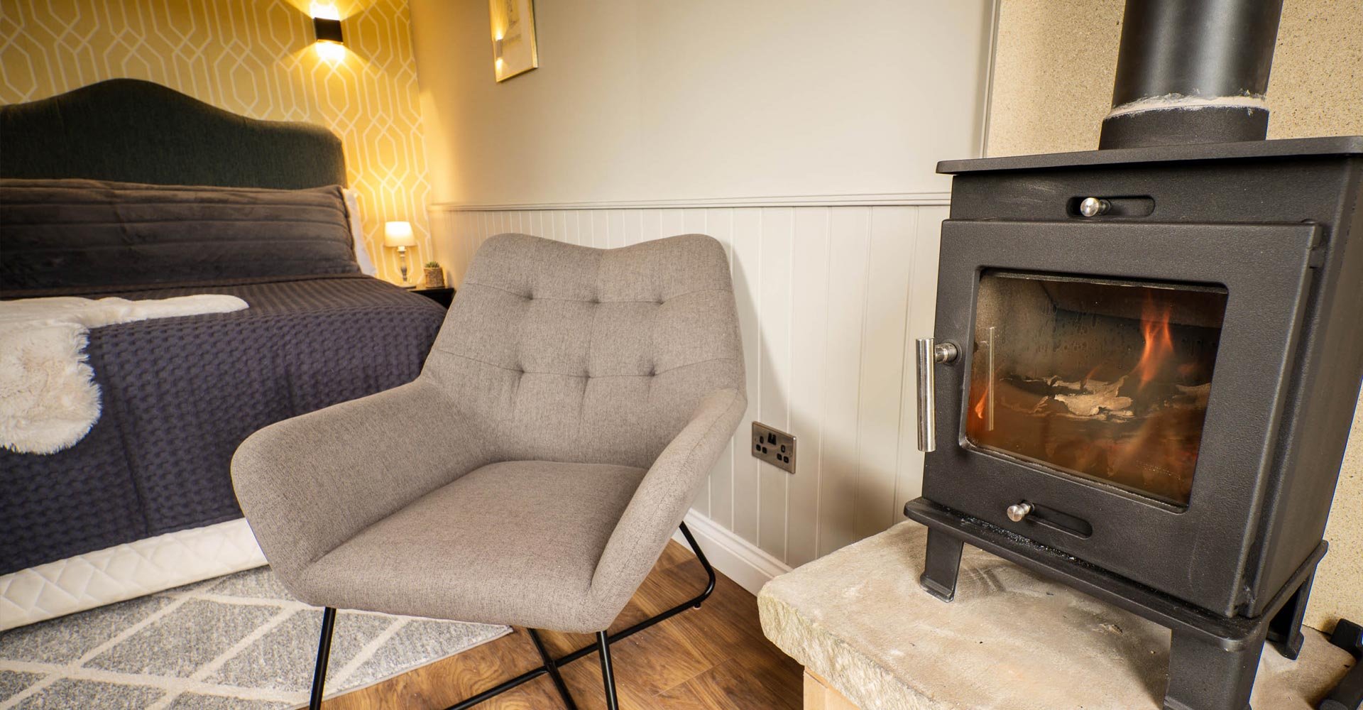 Clayfield Farm shepherd's hut log burner and armchair