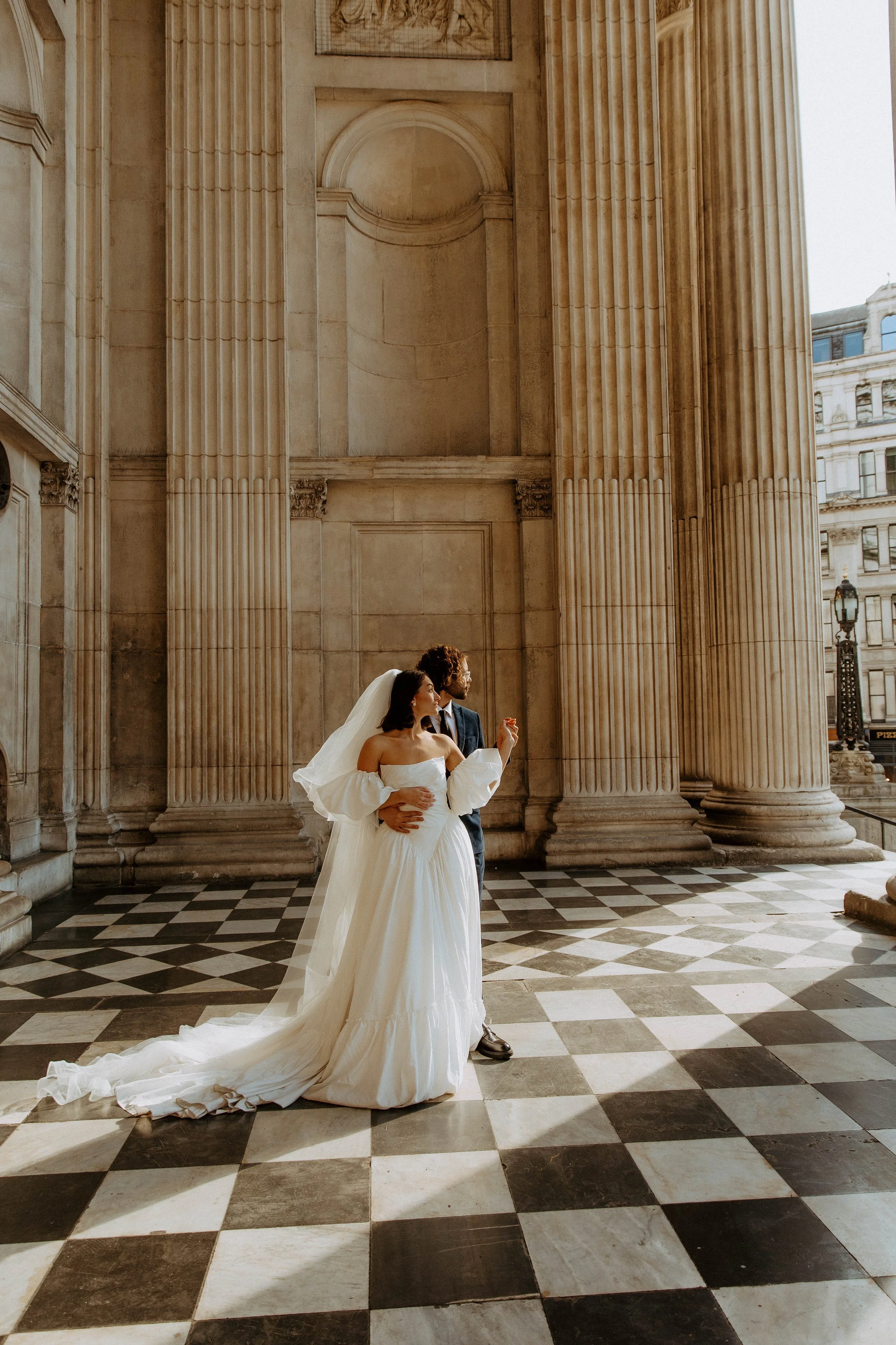  husband and wife embracing in their wedding photos 
