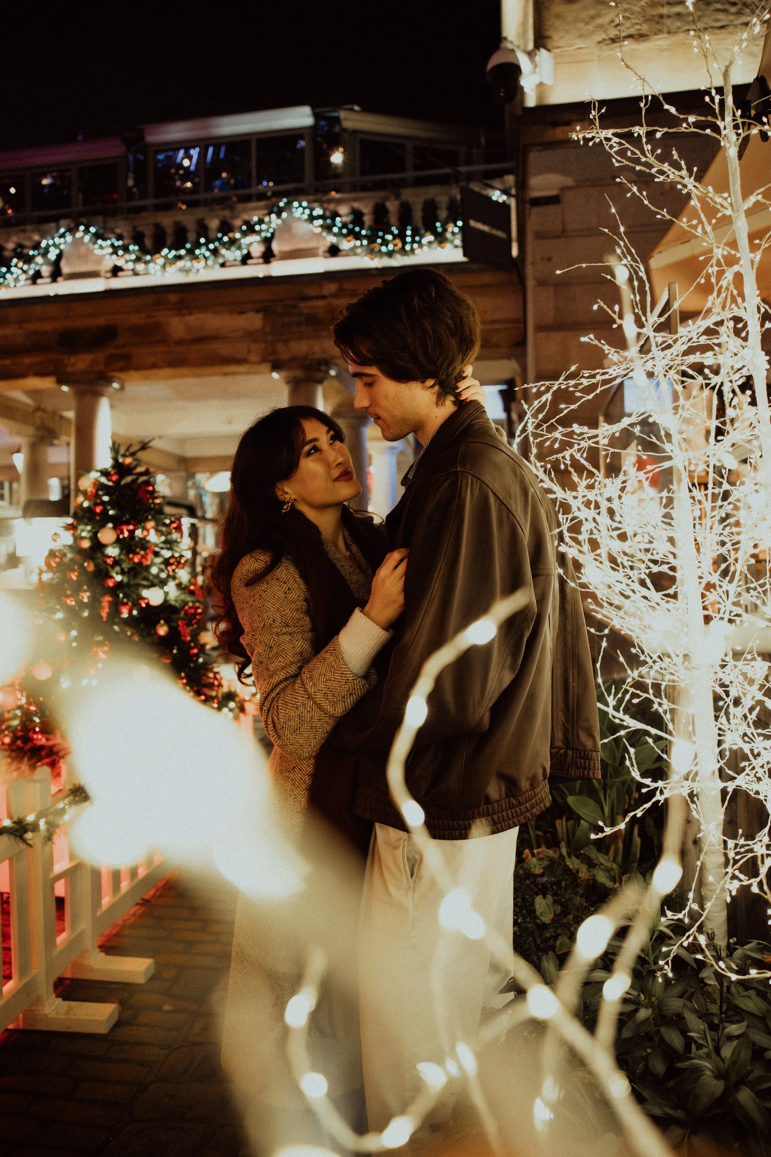  couple surrounded by christmas lights in London 