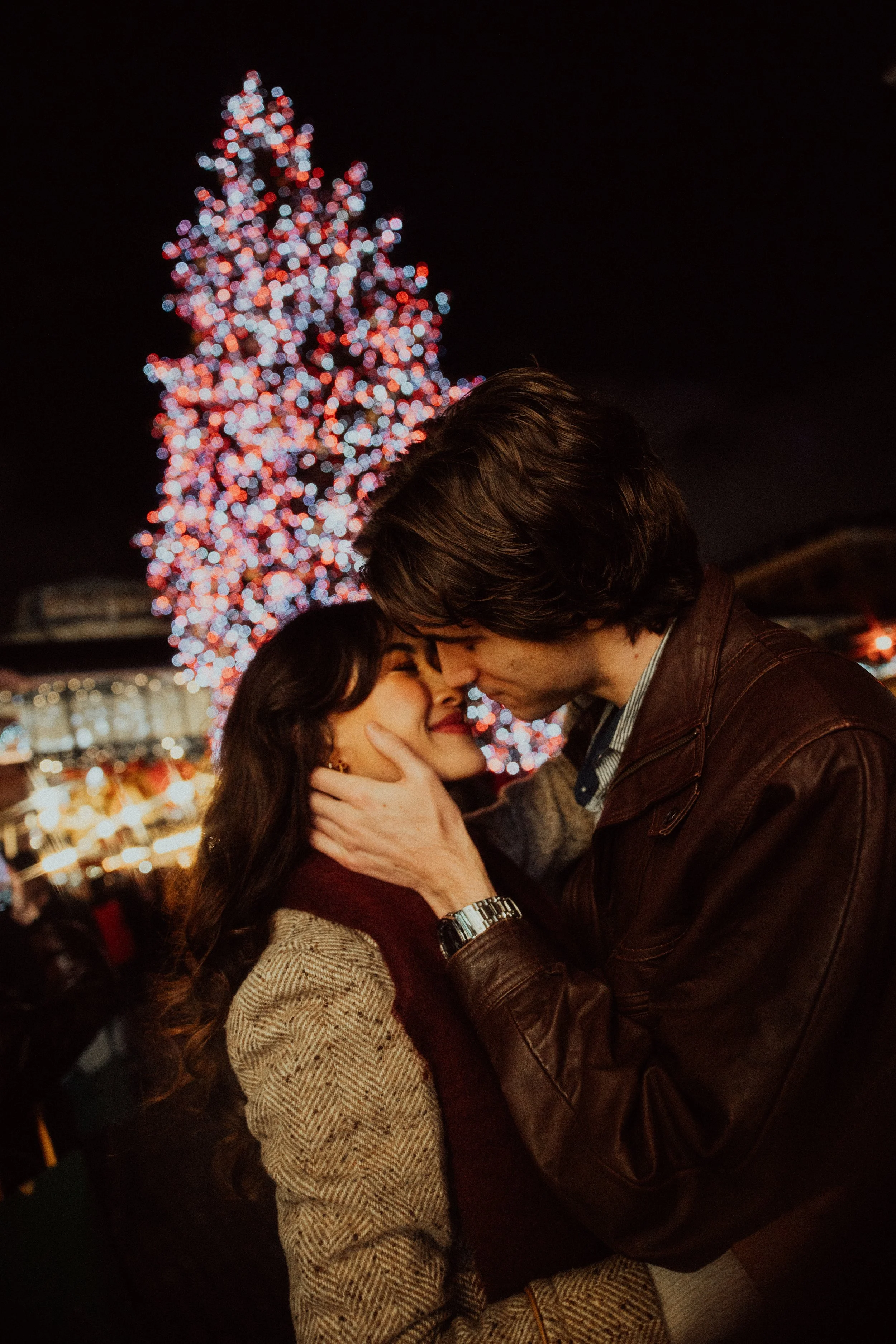 London couple in front of Christmas tree