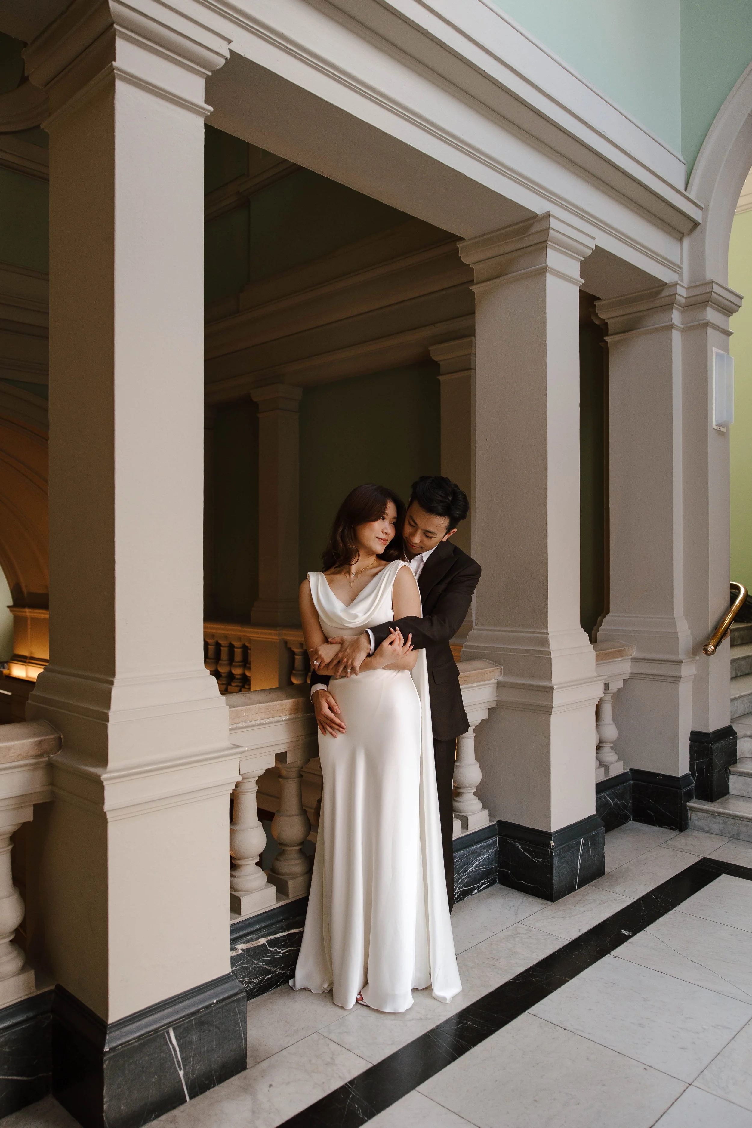 Justice holds Candace in an intimate pose during their museum photoshoot