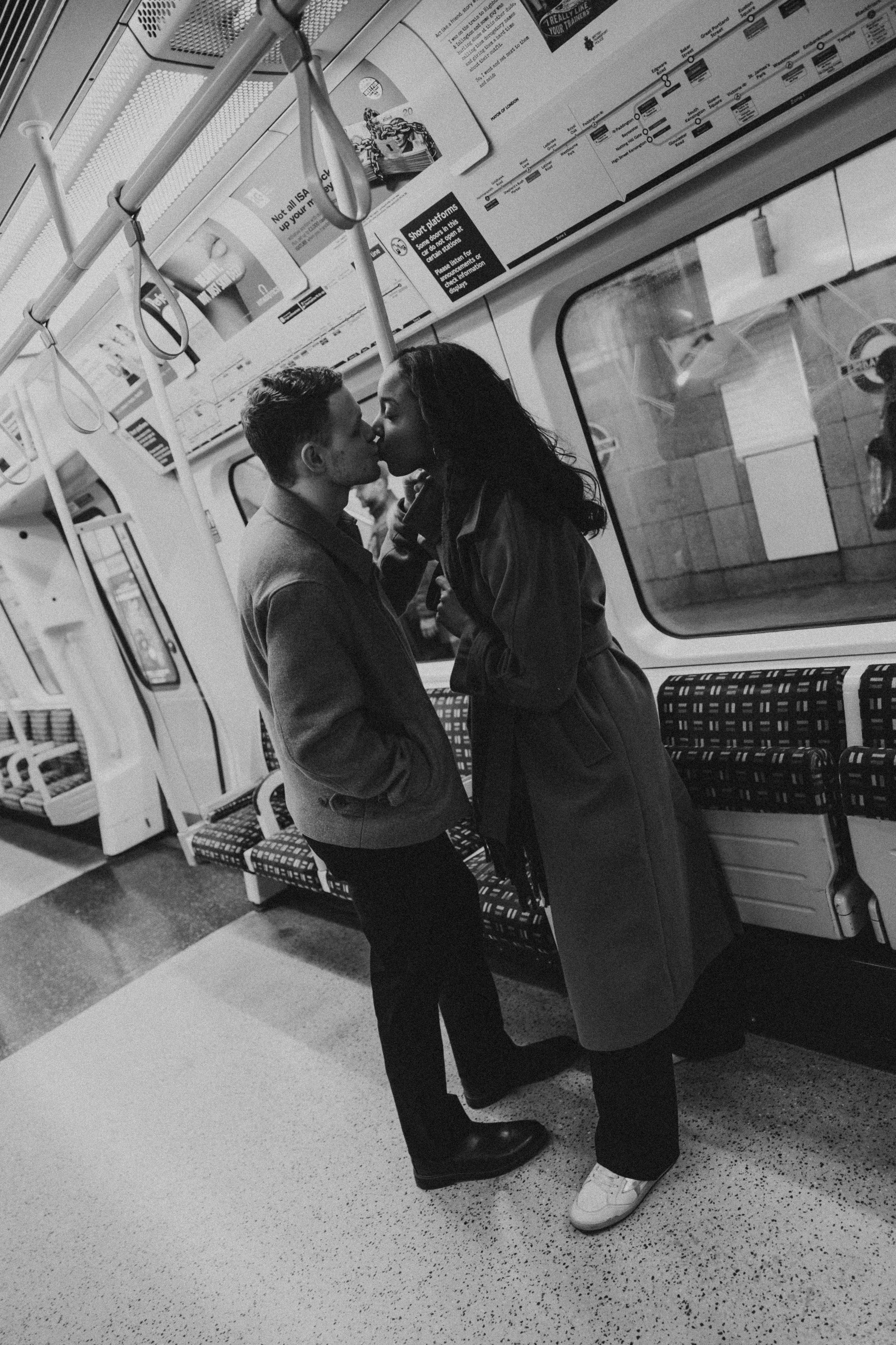 Amira and Caleb kissing on the subway