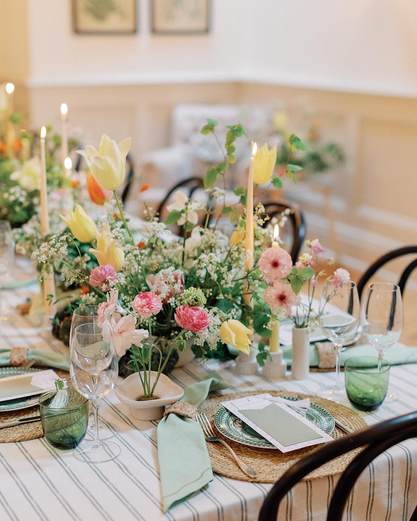 A fresh &amp; delicate Spring tablescape 💛

An organic display of British florals scattering the table, accompanied by seasonal veggies! 🥬

With stems grown by us, including tulips, geums, butterfly ranunculus. Topped up by beautiful flowers locall
