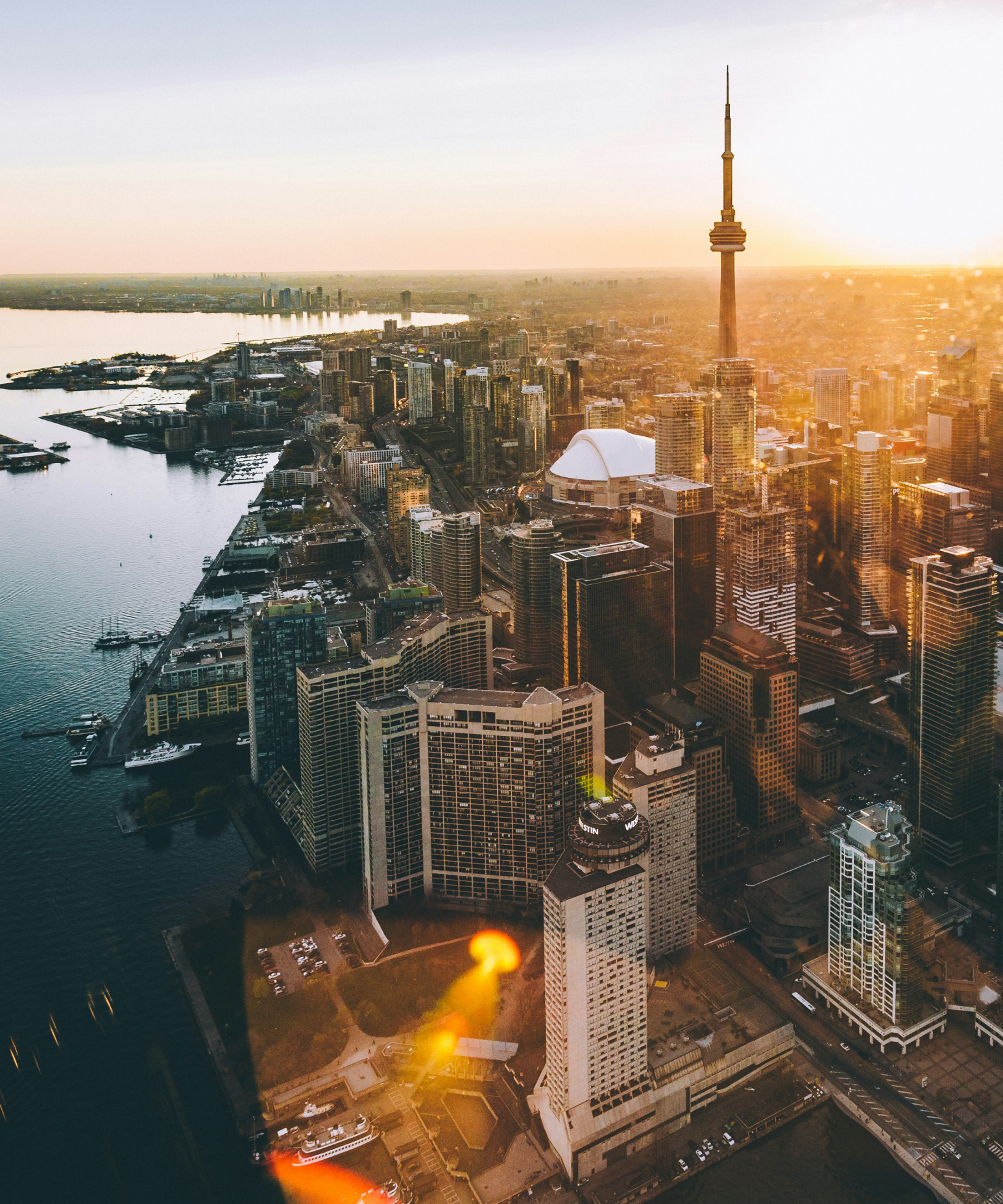 Aerial view of a bustling city at dusk, symbolizing Millenilink’s impact in enhancing tech workforce solutions across major urban centers.