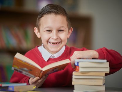 Pupil looking at books