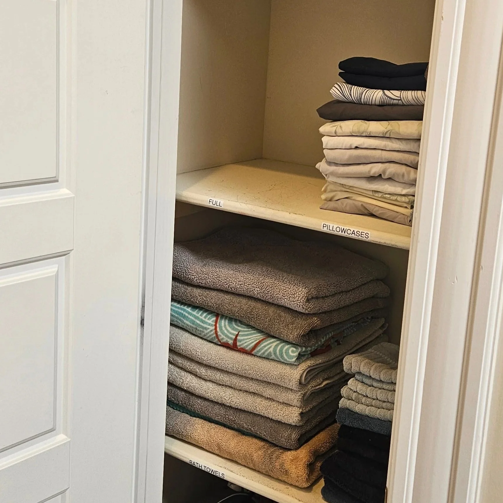 Linen closet organized by a professional organizer in Howard County, Maryland.