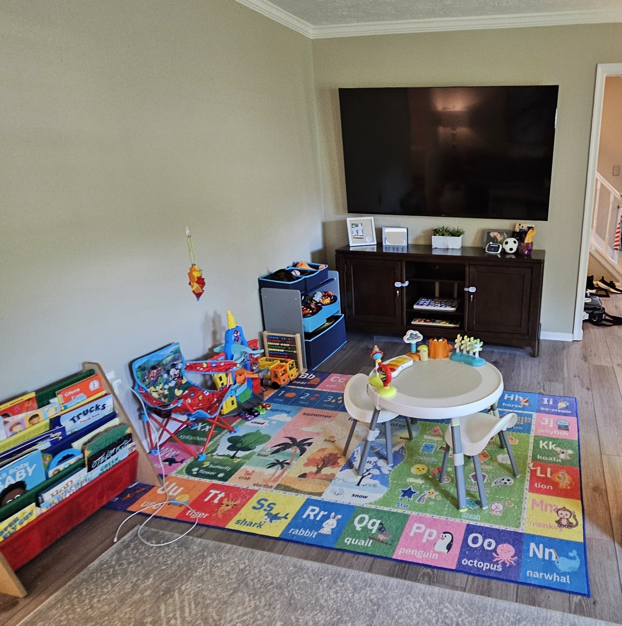 Living room with tv and toddler toys.