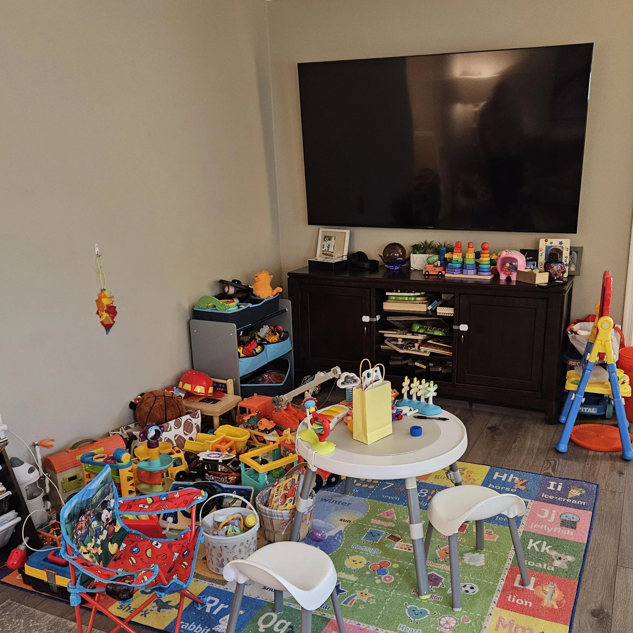 Messy living room with lots of toys.