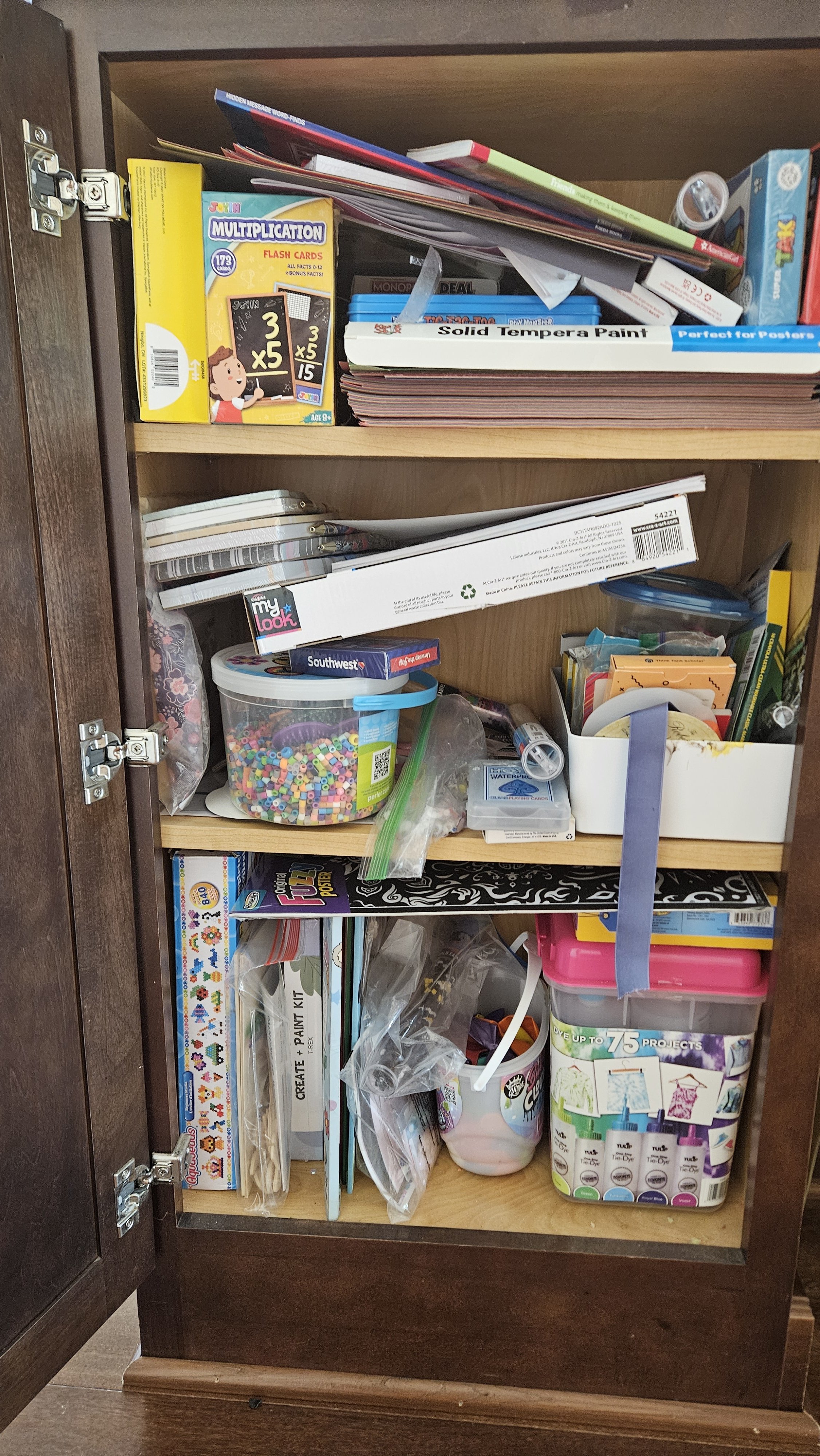 Cluttered craft cabinet. Before professional organizer came. Howard County, MD.