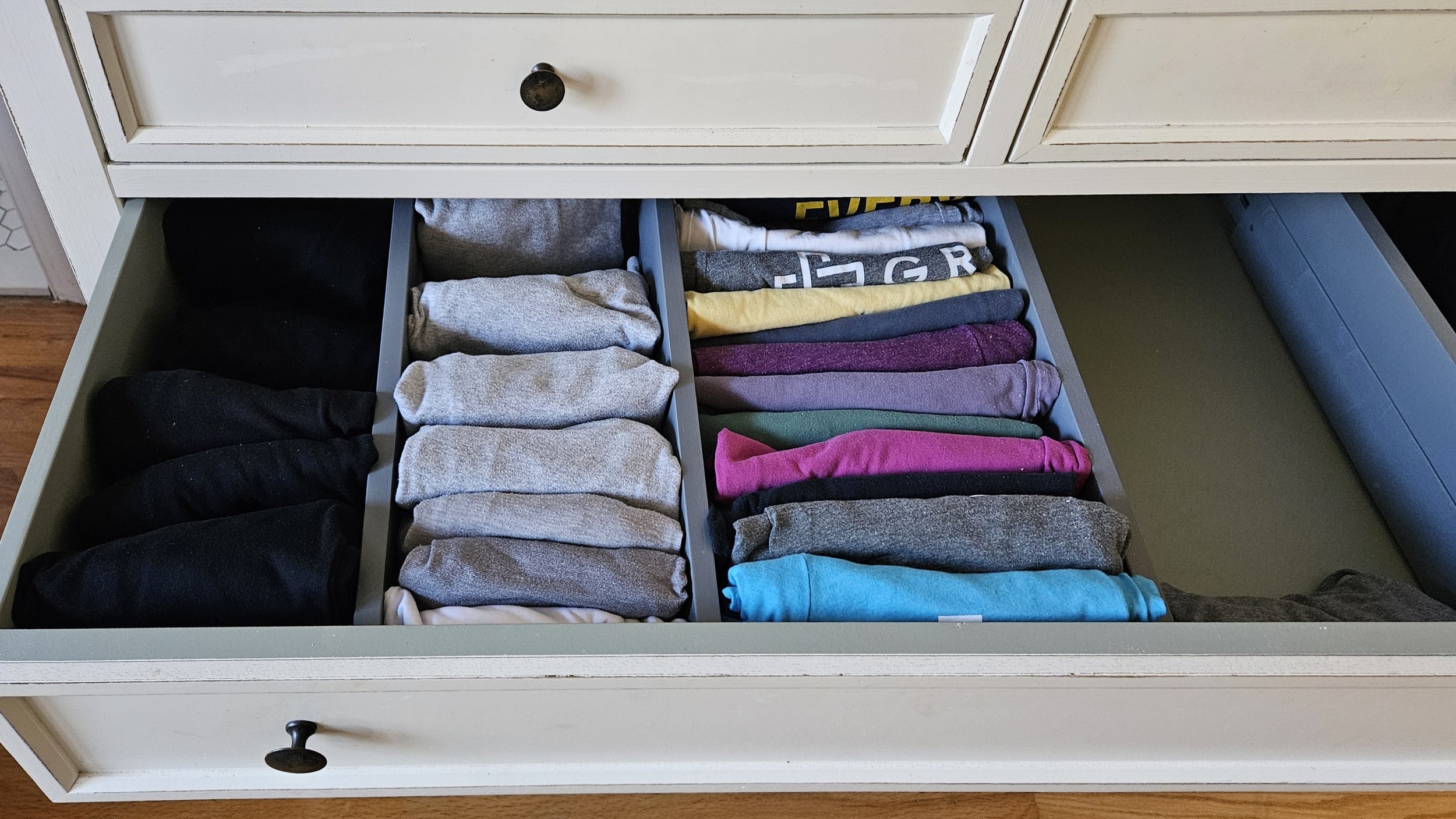 File folded tee shirts with drawer dividers. Professional organizer in Howard County, MD.
