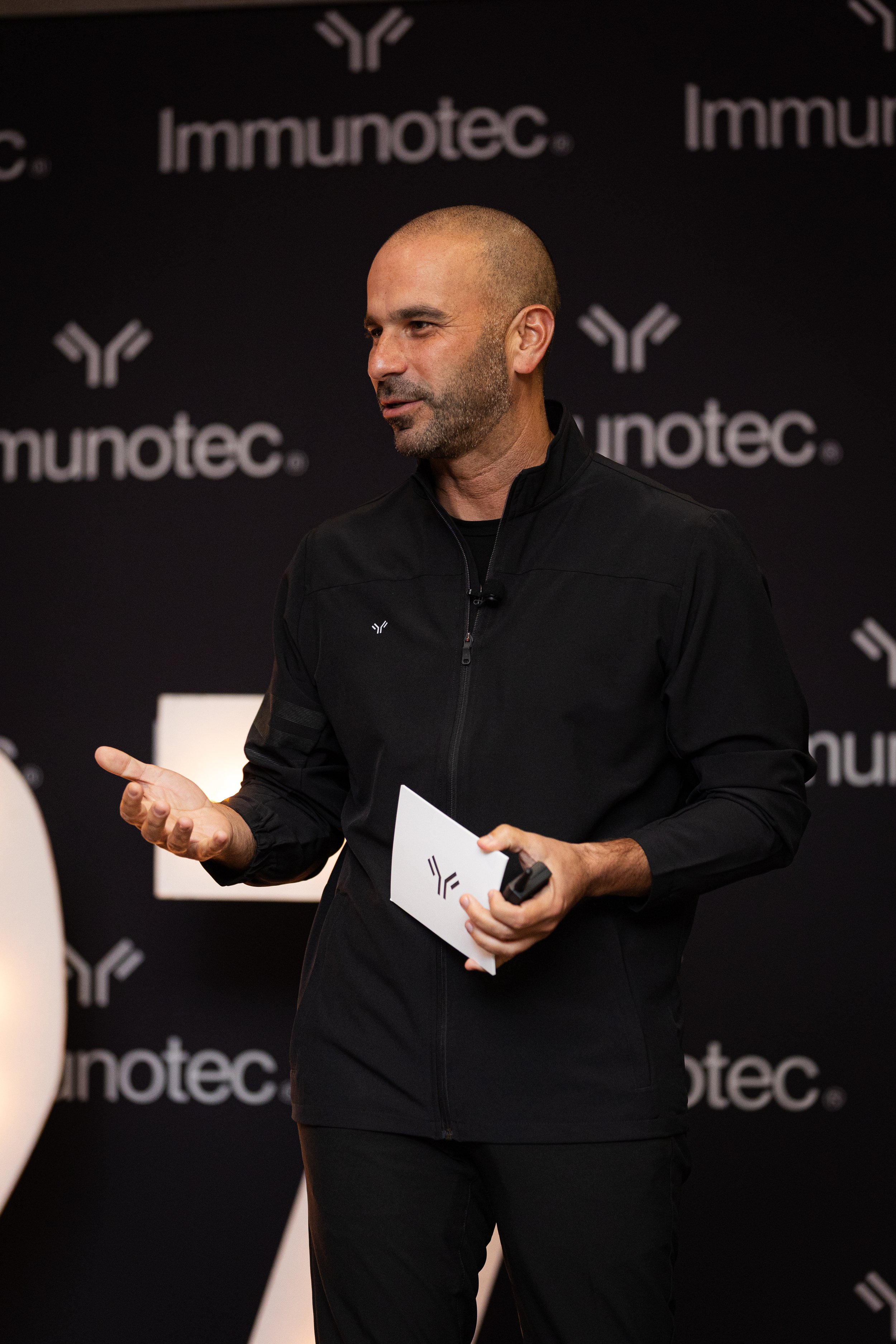 Professional corporate speaker at Immunotec event in The Woodlands, featuring high-quality AV equipment and stage lighting by Go Live Houston.