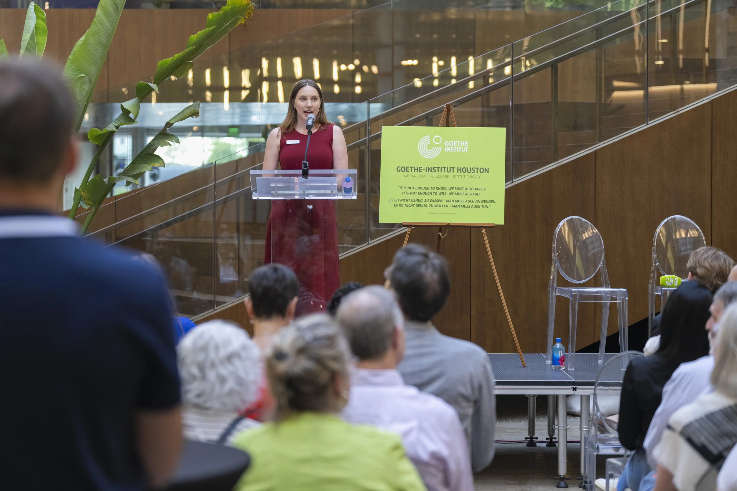 Keynote speaker presentation at the Goethe-Institut Houston cultural event, featuring professional audio and lighting setup.
