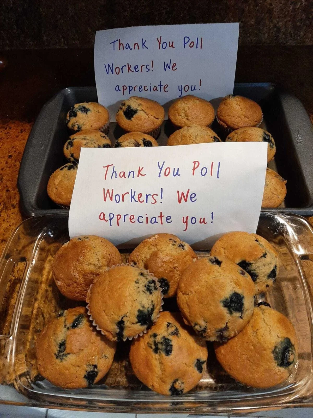Two trays of muffins with signs that say "Thank you poll workers! We appreciate you!"
