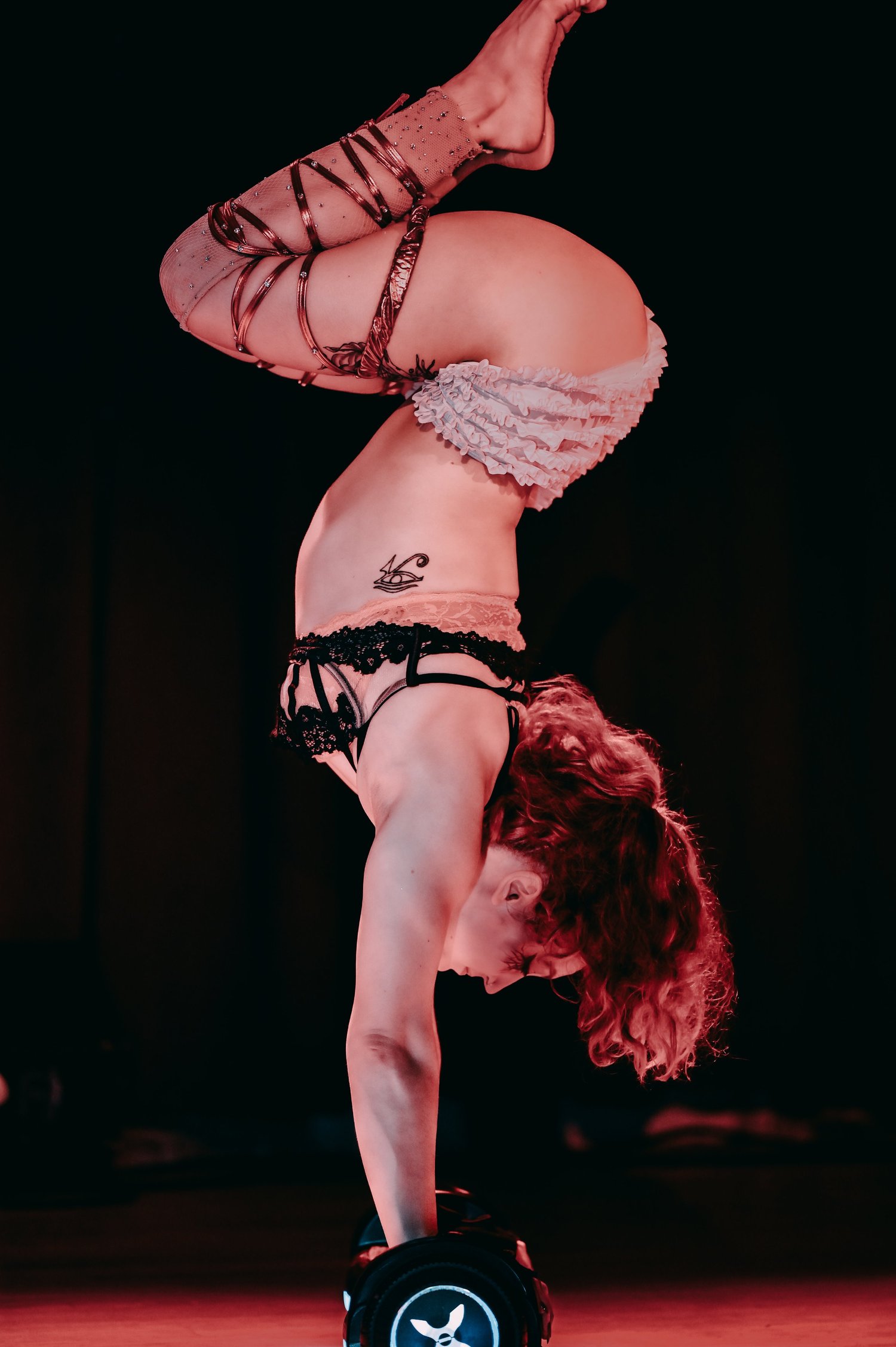 Talia Hazard handbalancing on a hoverboard