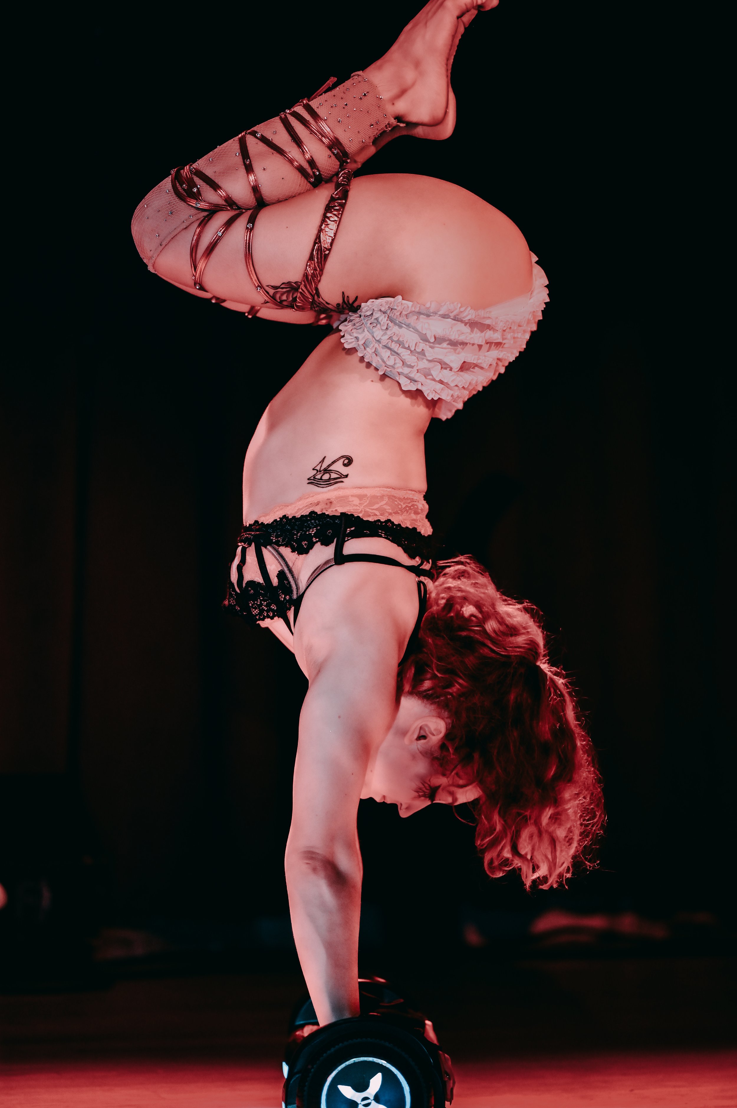 Talia Hazard handbalancing on a hoverboard